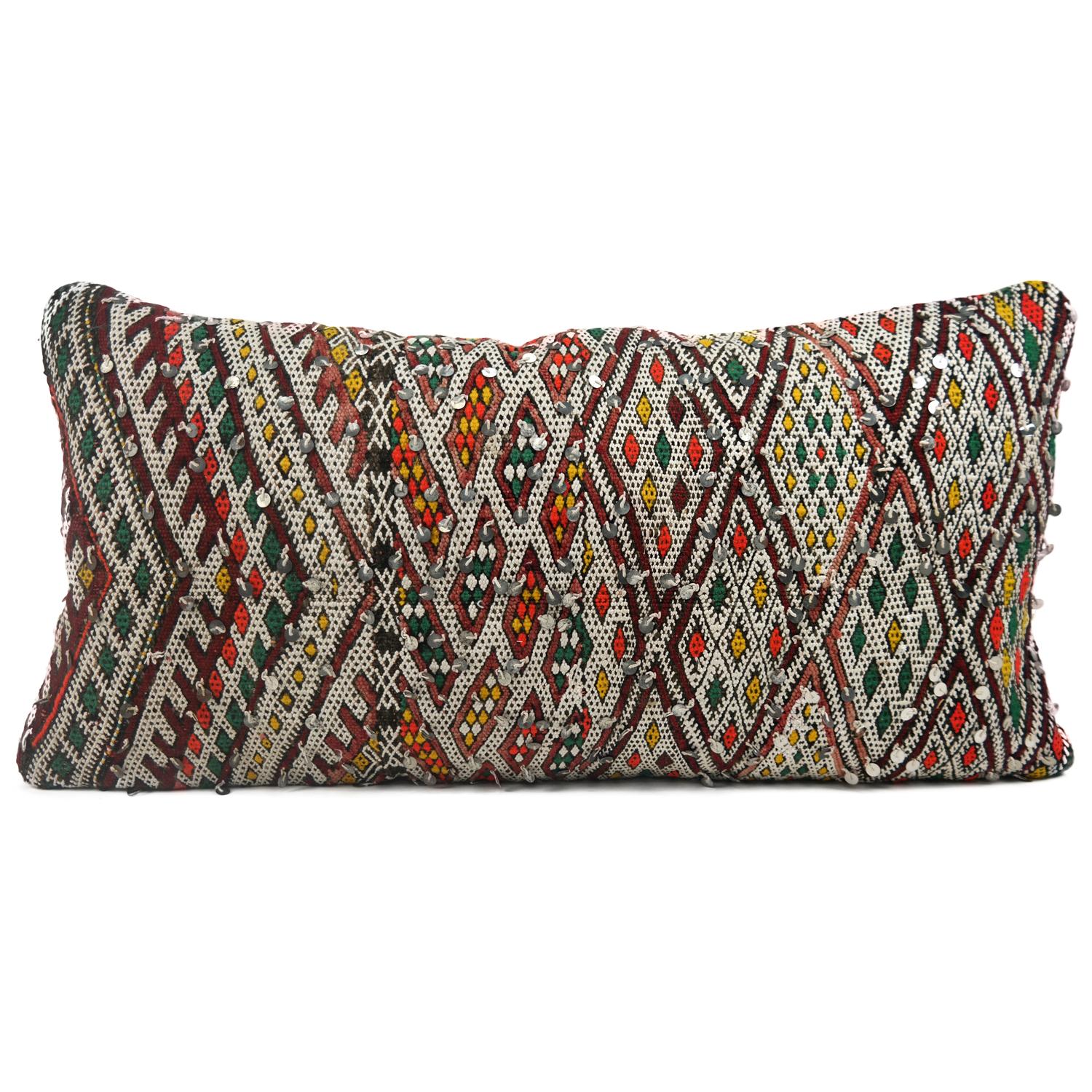 A stunning XL bohemian Moroccan kilim cushion custom made in Morocco. Cut from a circa 40 years old hand loomed kilim rug, from the Middle Atlas Mountains. We have searched and selected the rug ourselves. The pillow has beautiful colors like red,