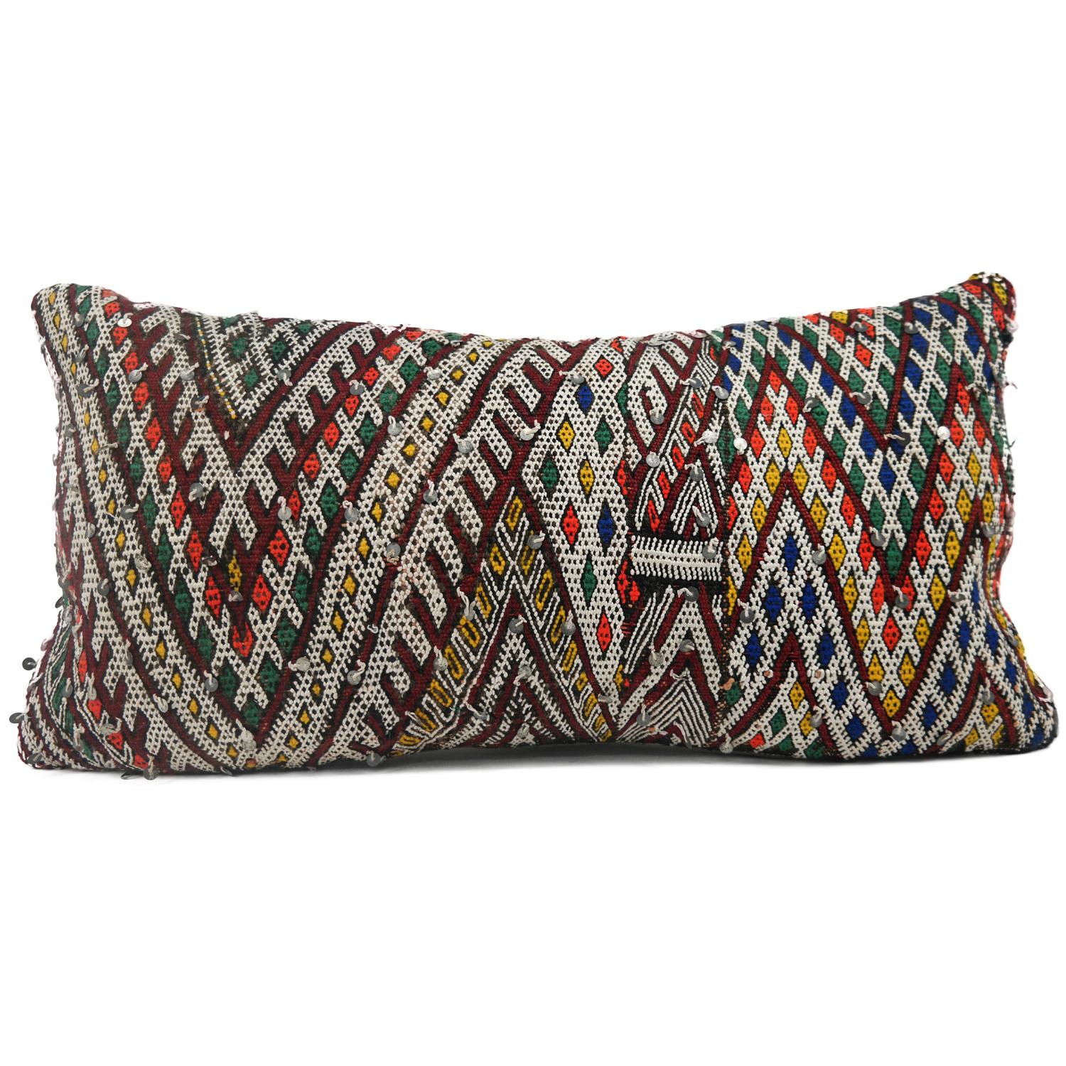 A stunning XL Bohemian Moroccan Kilim cushion custom made in Morocco. Cut from a circa 40 years old hand loomed Kilim rug, from the Middle Atlas mountains. We have searched and selected the rug ourselves. The pillow has beautiful colors like red,