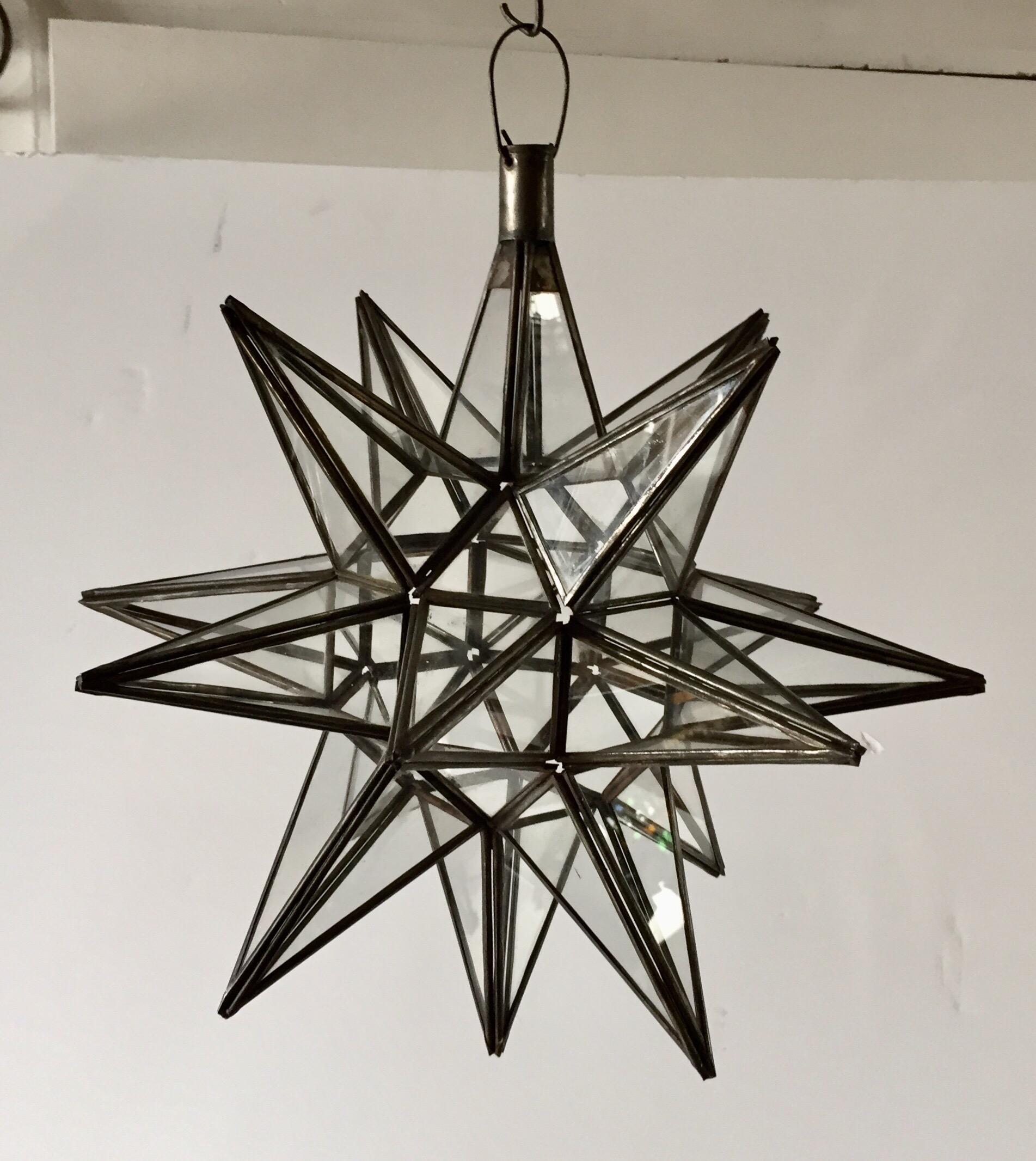Moroccan clear glass and metal framed Moravian star shape lantern
A beautiful vintage geometric metal and glass star pendant.
Multifaceted large star lantern with glass panels that form geometrical shapes similar to Moravian stars.
The lantern