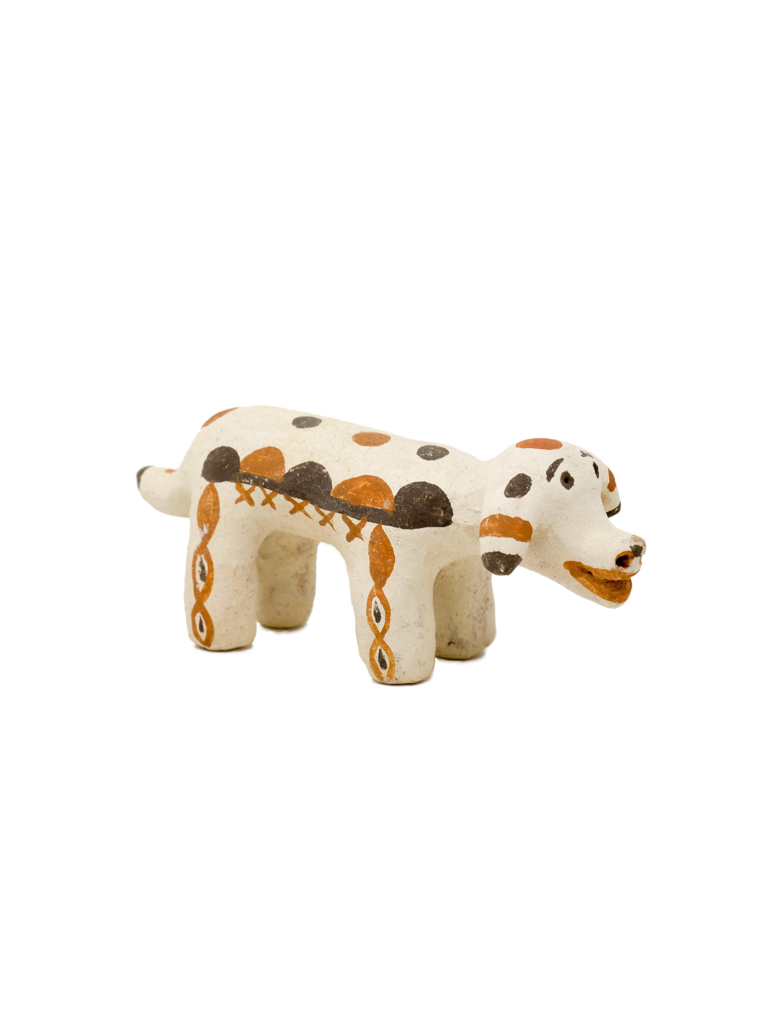 - Hand built decorative dog sculpture
- made of clay collected from the potter's surroundings.
- decorative motifs painted with a goat hair brush made by the potter to apply natural pigments.
- made in the Moroccan Rif mountains by