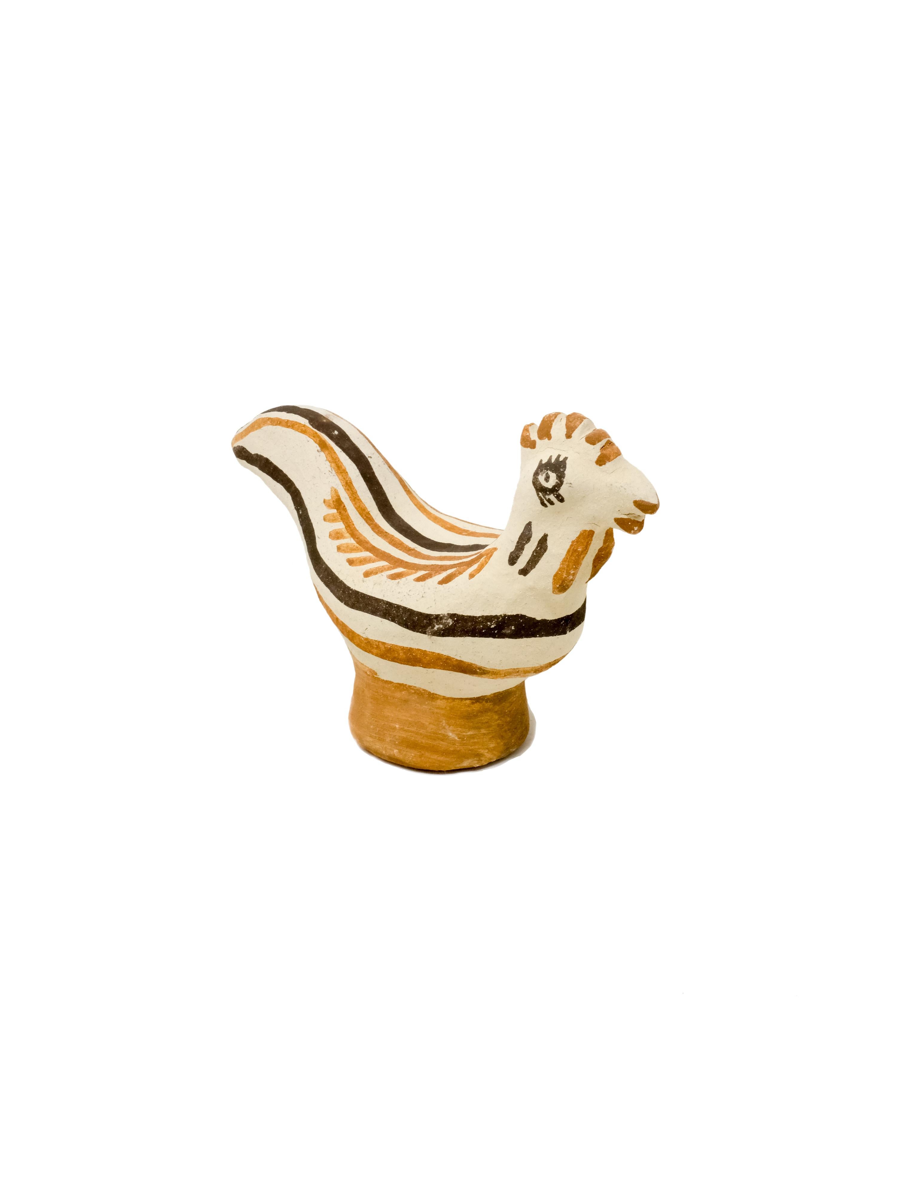 - Hand built decorative hen sculpture
- made of clay collected from the potter's surroundings.
- decorative motifs painted with a goat hair brush made by the potter to apply natural pigments.
- made in the Moroccan Rif mountains by
