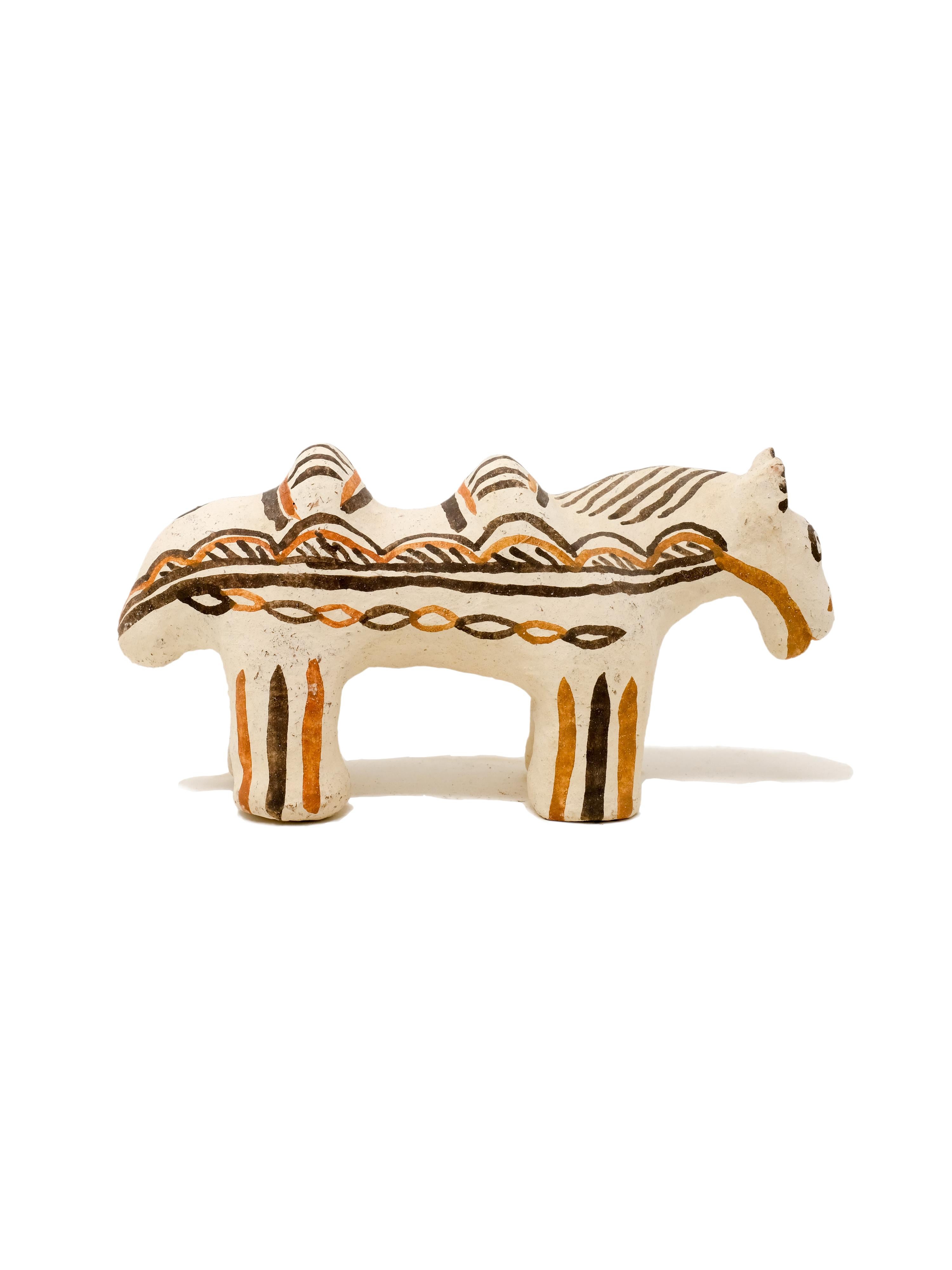 - Hand built decorative horse sculpture
- made of clay collected from the potter's surroundings.
- decorative motifs painted with a goat hair brush made by the potter to apply natural pigments.
- made in the Moroccan Rif mountains by