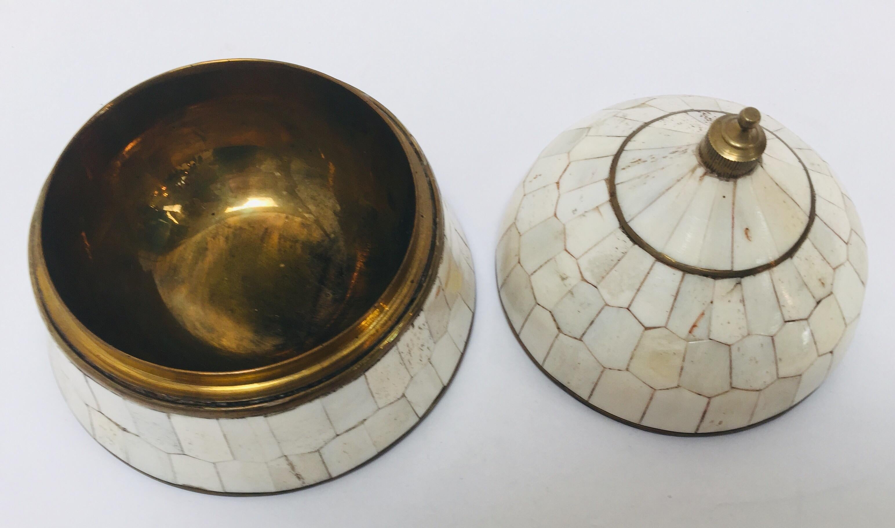 Moroccan decorative round bell shaped lidded box inlaid with bone and brass.
Stylish round bell shaped Moorish trinket lidded box handcrafted with polished brass and bone inlaid, brass lined inside.
Moroccan lidded box handcrafted in Marrakech,