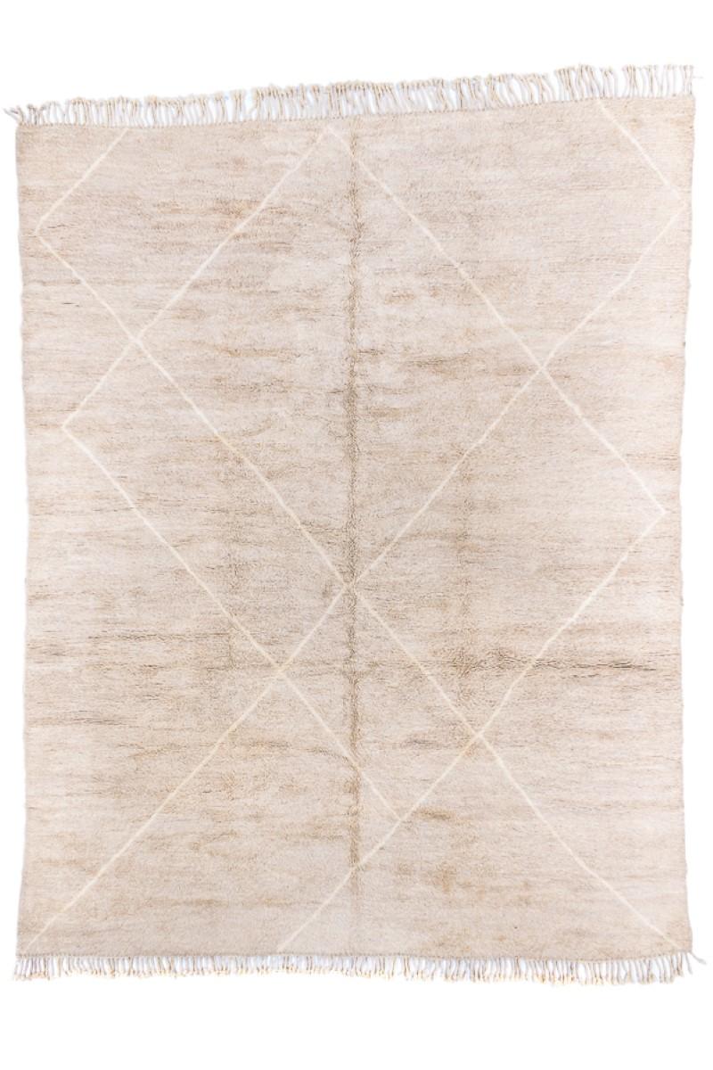 This coarse woven, deep pile, North African piece, shows an abrashed, natural-looking borderless sand ground crisscrossed by artfully placed, randomly spaced, widely set, ecru lines, running nearly the full length of the carpet. Both ends have