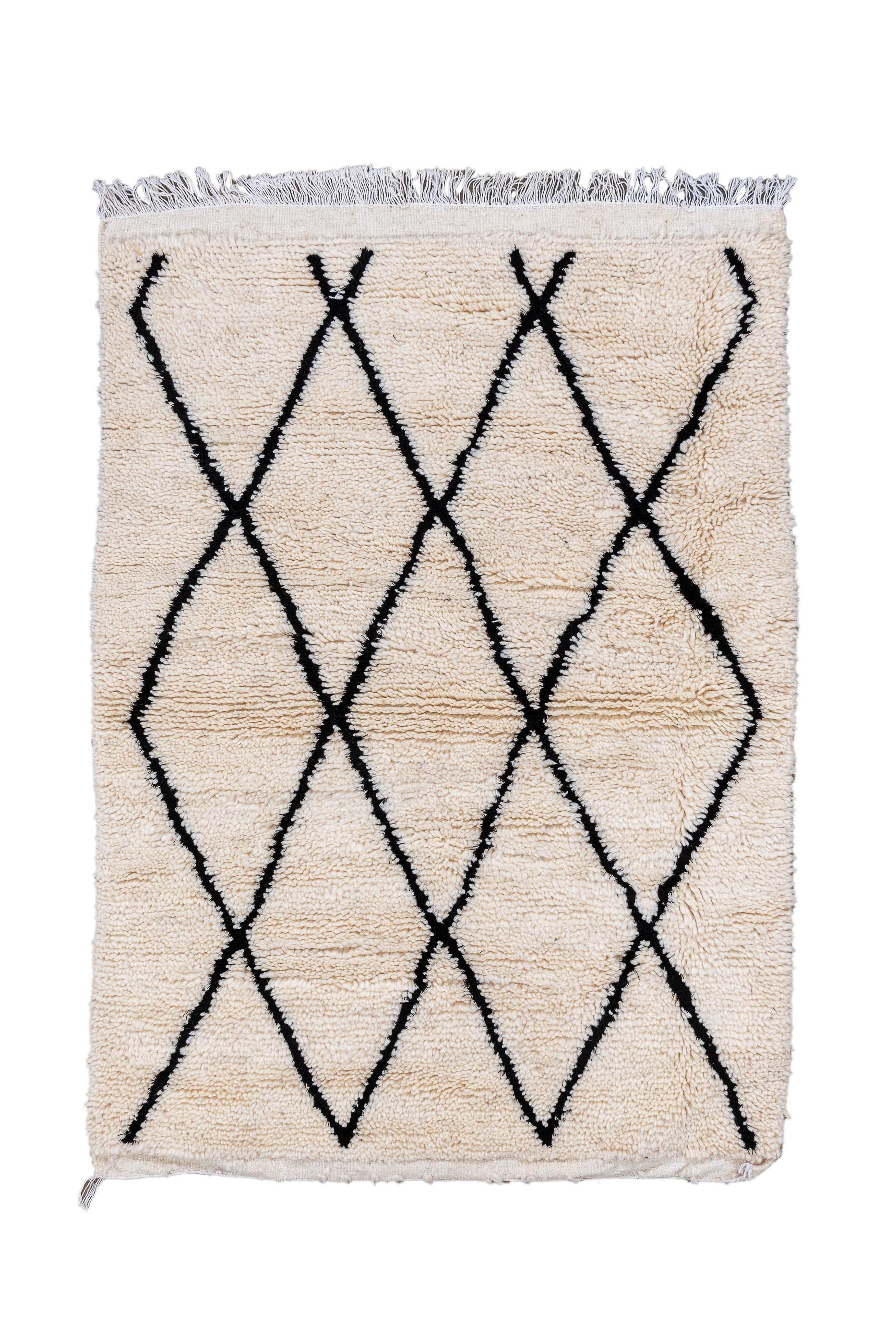 Moroccan weavers love lozenges. This rug has a bolder design emphasizing thick charcoal diagonal lines and lacking side borders. The open lozenge lattice is not quite balanced, end-to-end. Coarse weave, long pile. As new condition.Measures: 3'2x4'6
