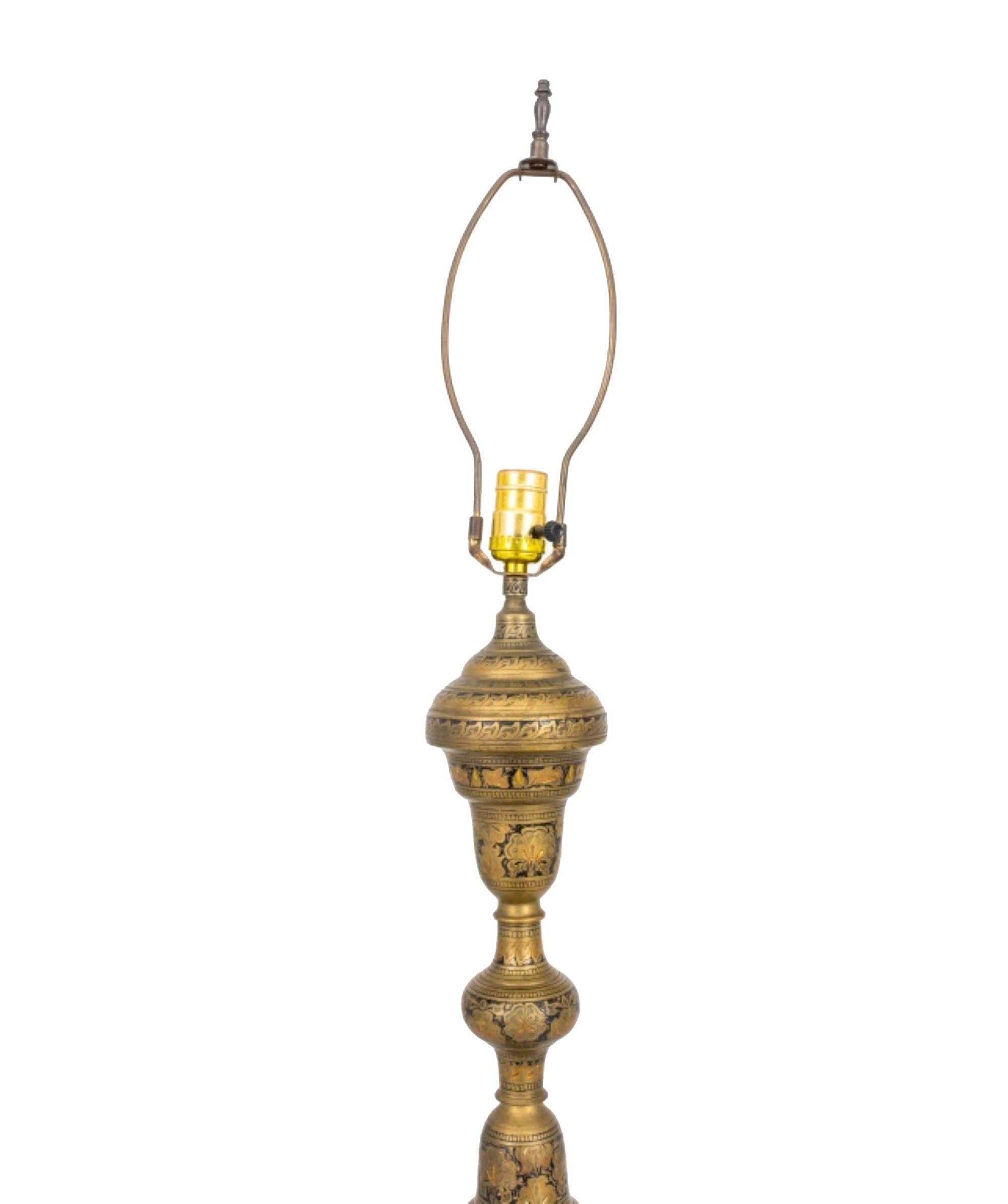 The Moroccan engraved brass floor lamp is approximately 64 inches in height, and the base has a diameter of 10 inches.





