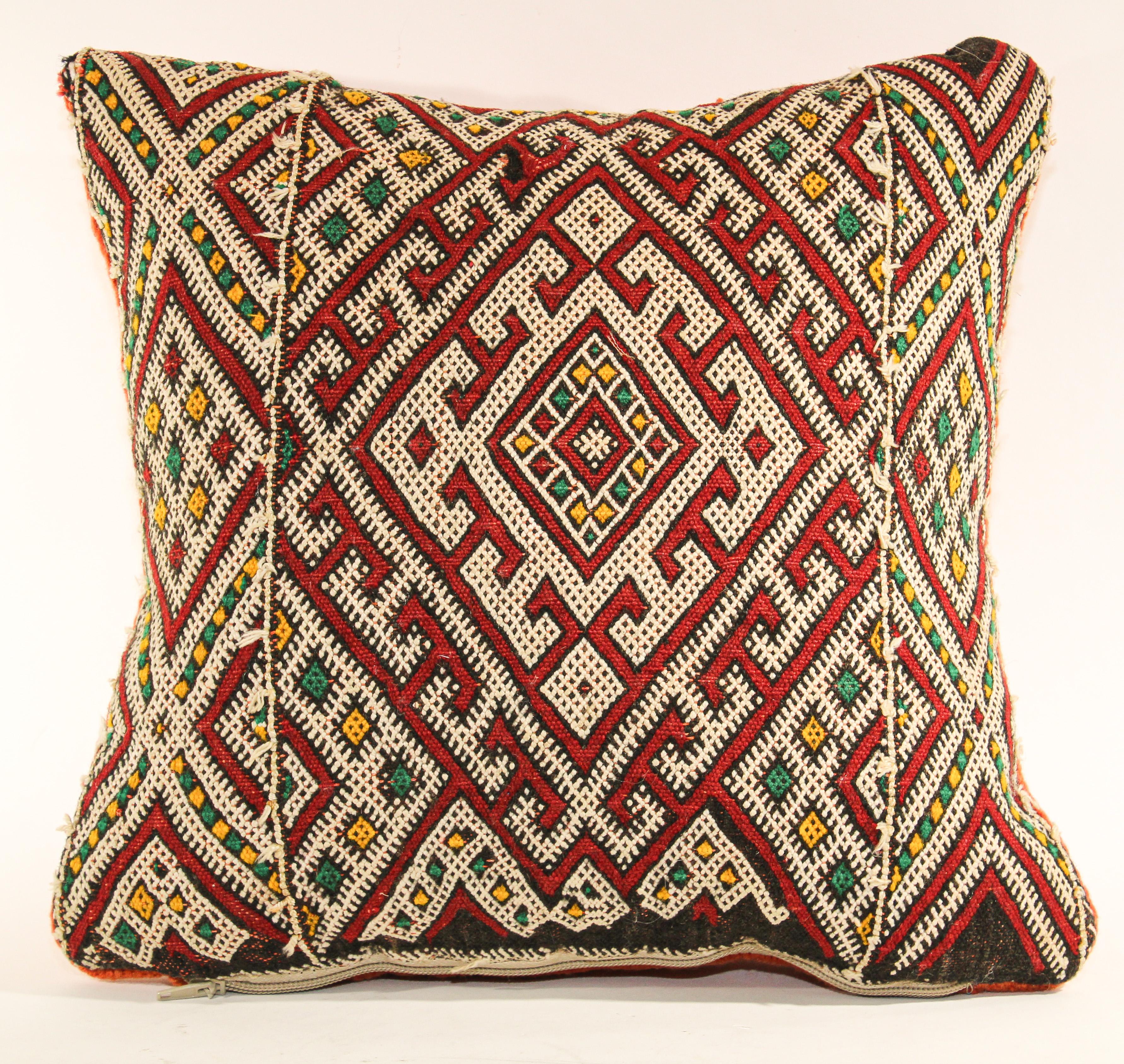 Moroccan Ethnic Berber handwoven tribal throw pillow made from a vintage rug.
The front and the back are made from a different rug, front is more elaborate and back is more plain.
Geometric North African tribal designs in red, white and black and