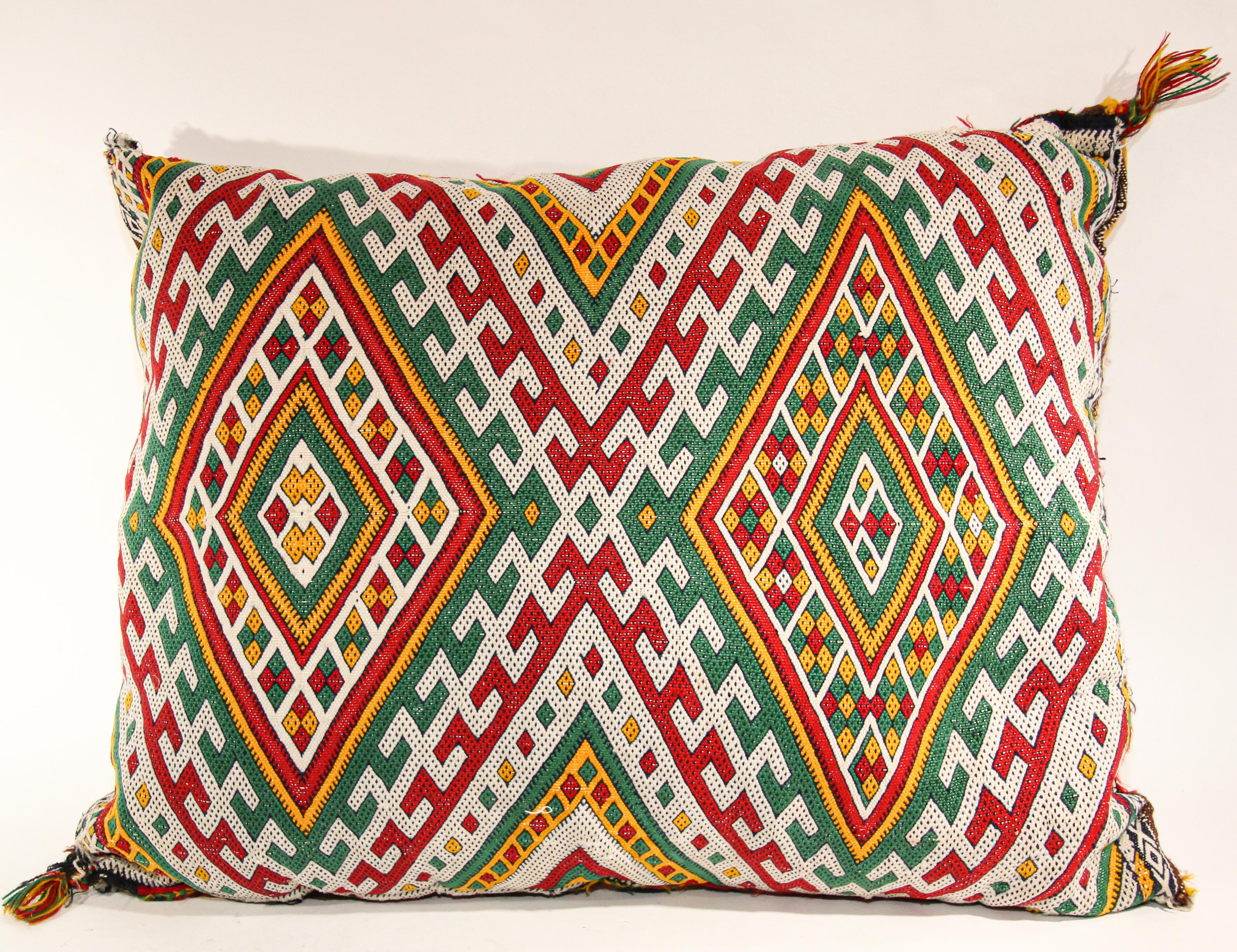 Moroccan Berber ethnic handwoven tribal throw pillow made from a vintage rug.
The front and the back are made from a different rug, front is more elaborate and back is more plain.
Geometric North African tribal designs in red, white and black and