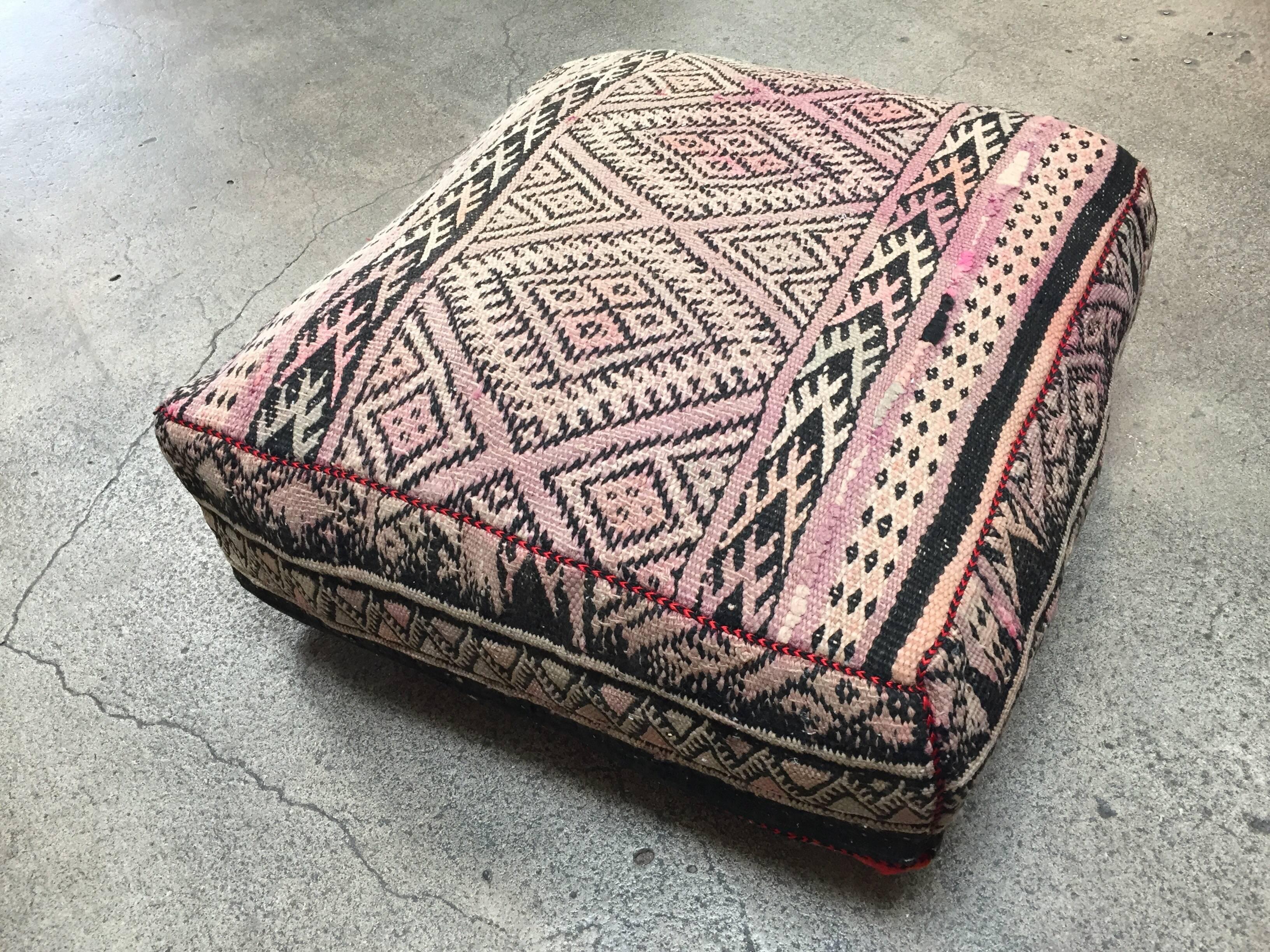 Moroccan vintage floor pillow seat cushion made from a Tribal kilim flat weave Berber rug.
Square shape with nice faded earth tone colors for the top and rich warm stripes colors for the bottom.
Great addition for any Bohemian or Modern