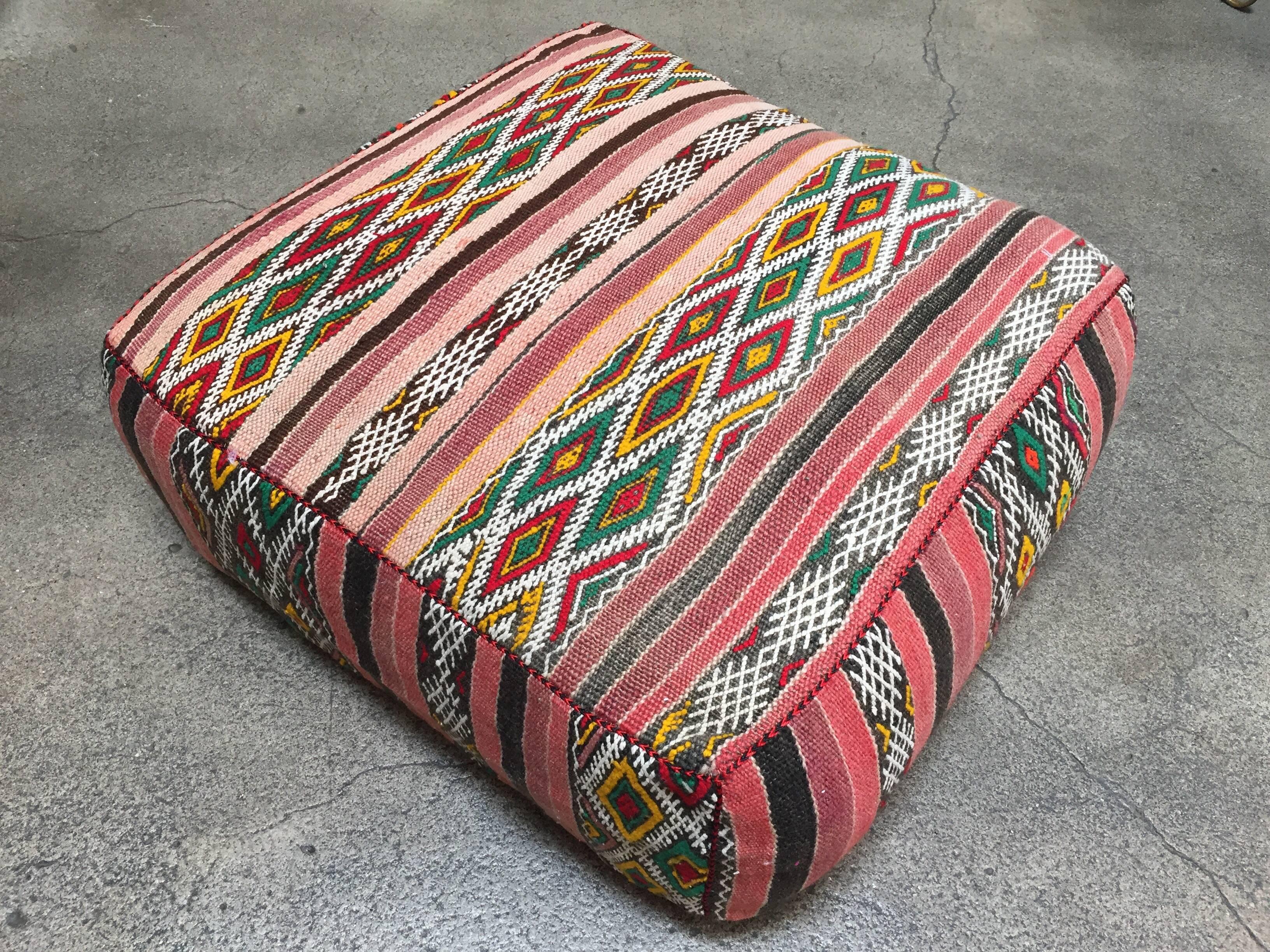 Moroccan vintage floor pillow seat cushion made from a Tribal Berber rug.
Square shape with nice faded earth tone colors for the top and rich warm stripes colors for the bottom.
Great addition for any Bohemian or Modern interior.
Made from a vintage