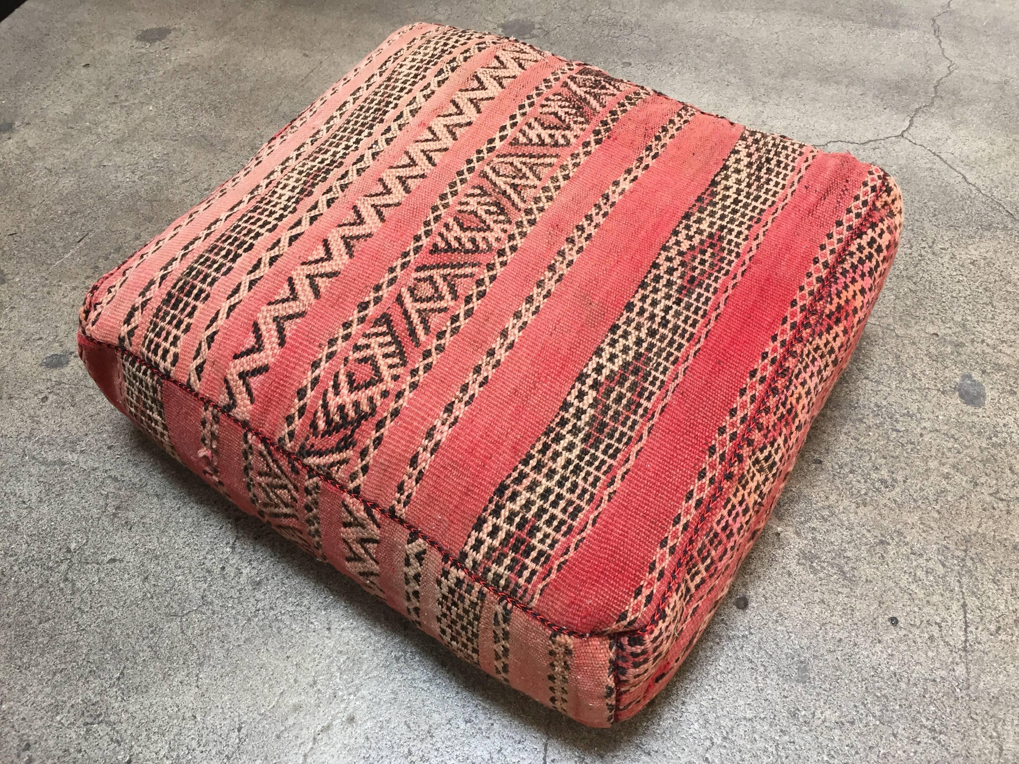 Moroccan vintage floor pillow seat cushion made from a Tribal Berber rug.
Square shape with nice faded earth tone colors for the top and rich warm stripes colors for the bottom.
Great addition for any Bohemian or Modern interior.
Made from a