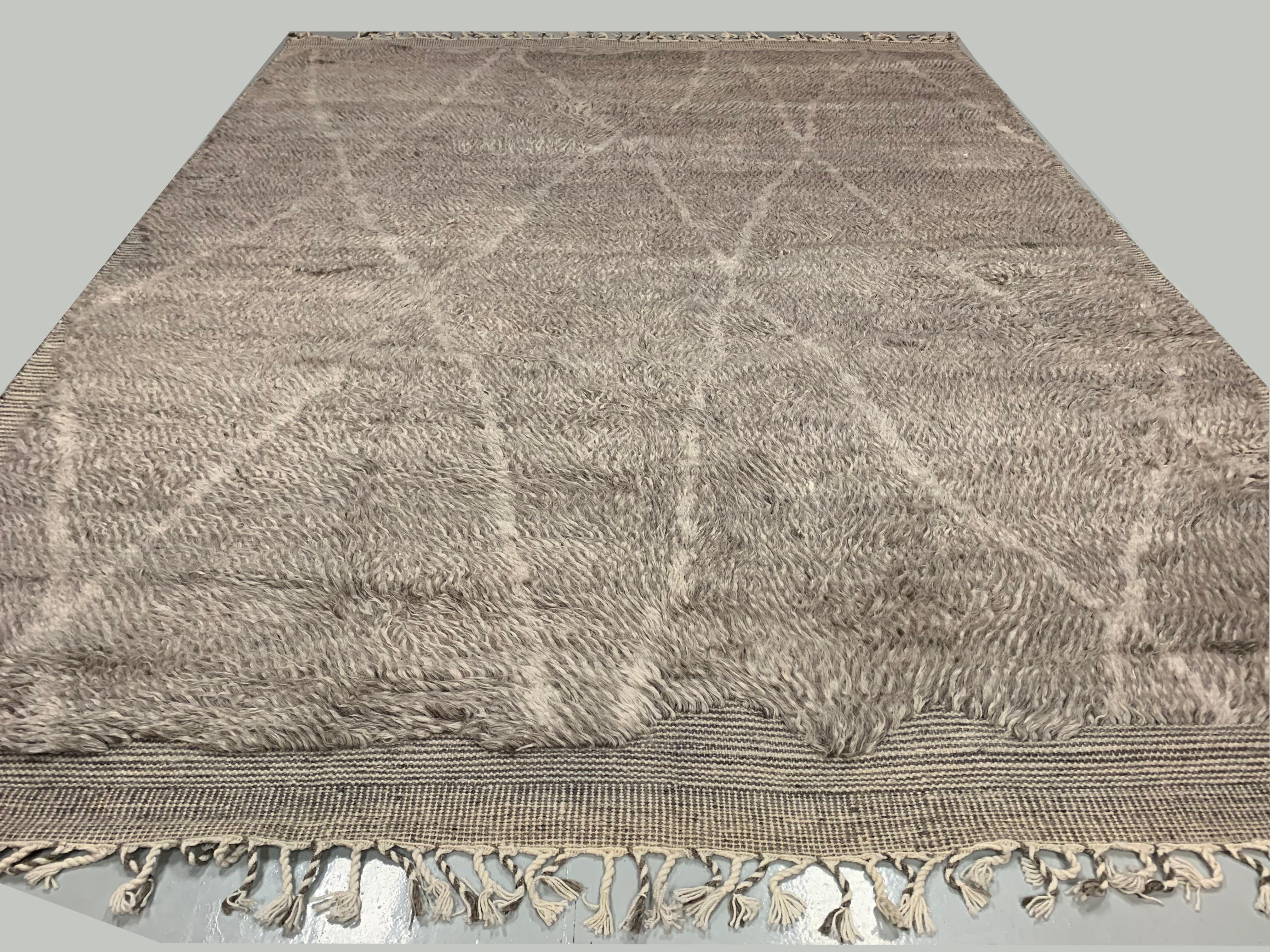 Moroccan Style Fluffy Collection rug. Measures: 10'1 x 13'11. Using the finest of wools these handwoven recreations of Moroccan Classic designs bring a feeling of warmth and luxury to any setting. Colors: gray/ivory.