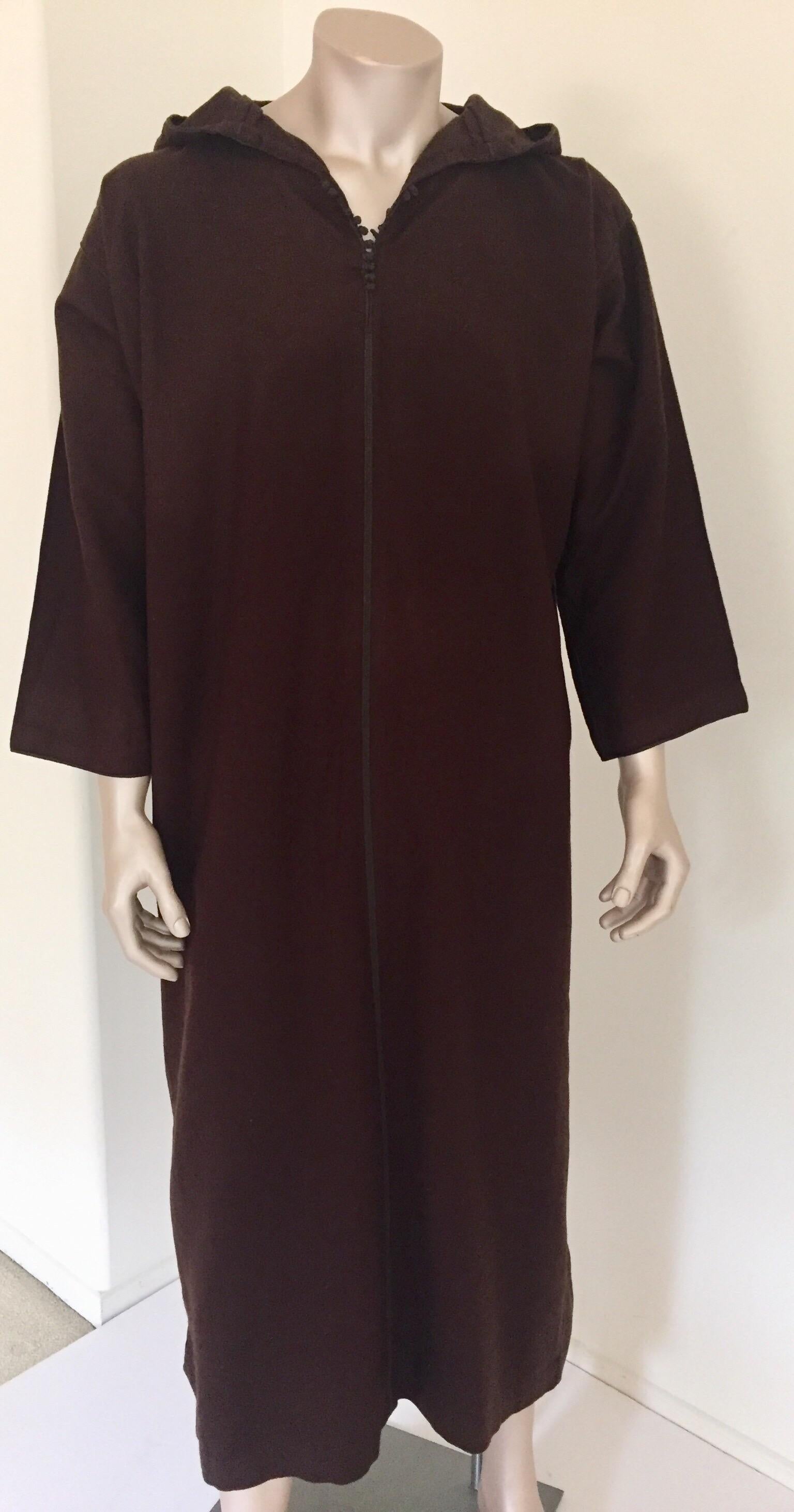 Moroccan traditional gentleman handcrafted hooded wool cashmere djellaba.
Moroccan traditional ethnic gentleman kaftan coat in dark chocolate brown wool.
This North African long hooded kaftan coat features a traditional form with side slits and long
