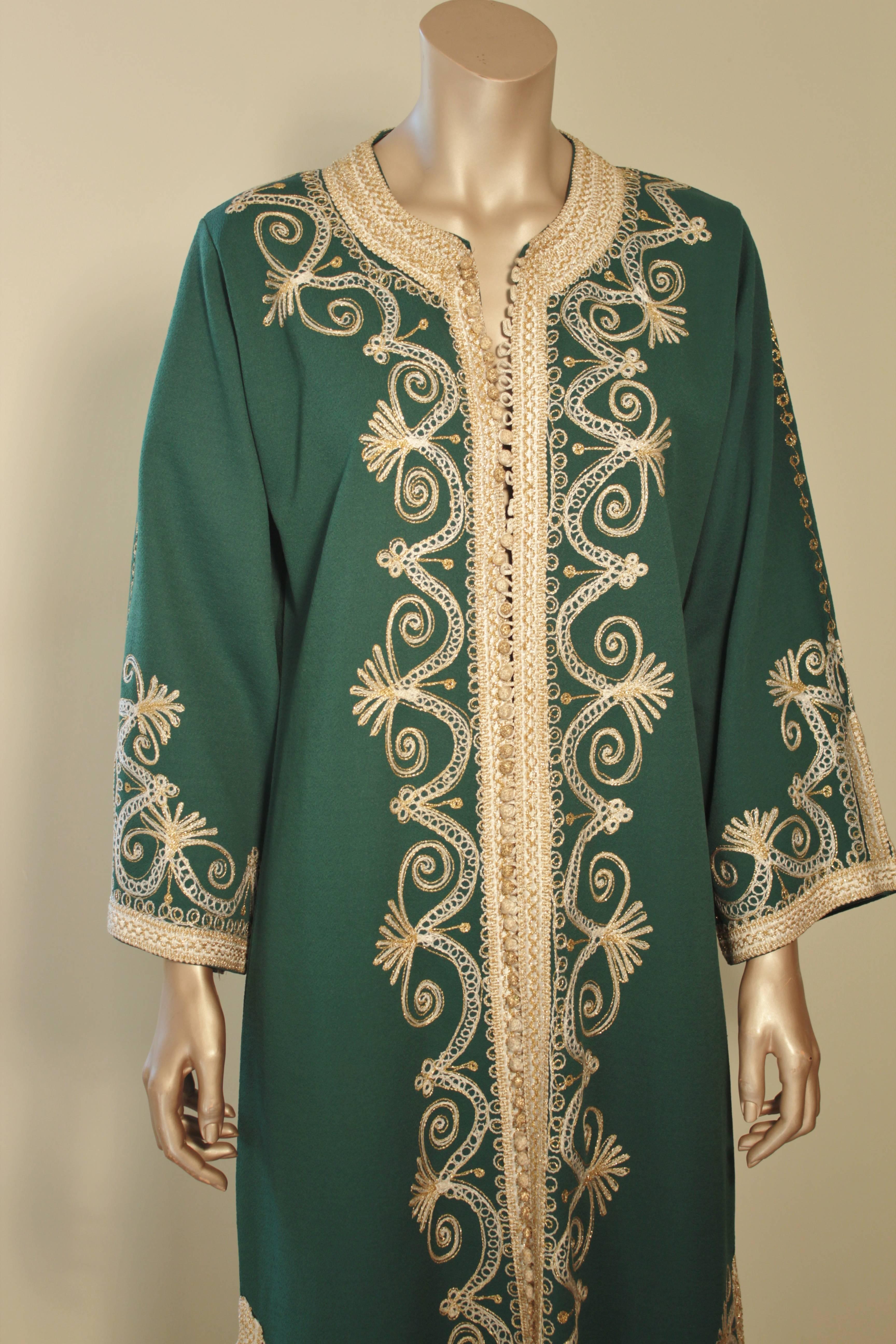 Vintage Moroccan green and gold embroidered caftan.
Elegant vintage Moroccan Kaftan, embroidered with gold threads design all over. 
The maxi poly jersey dress kaftan features a traditional neckline, with side slits and gently fluted embellished