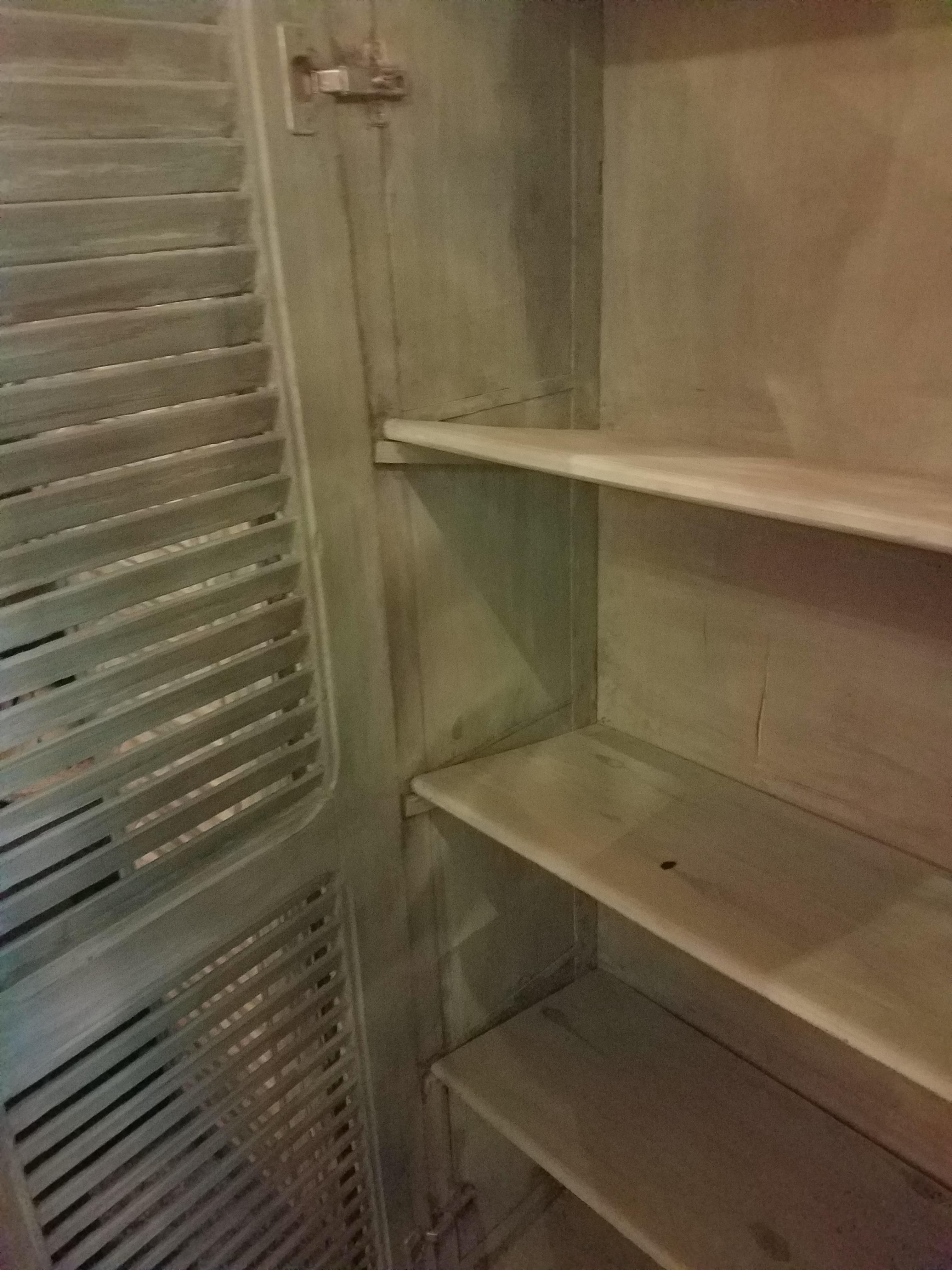 Aged green handmade Moroccan cedar wooden cabinet measuring 59” in height, 35” in width, and 13” in depth, using the traditional whitewash method. This amazing cabinet features 4 angled shelves, perfect especially for shoe storage, but can also be