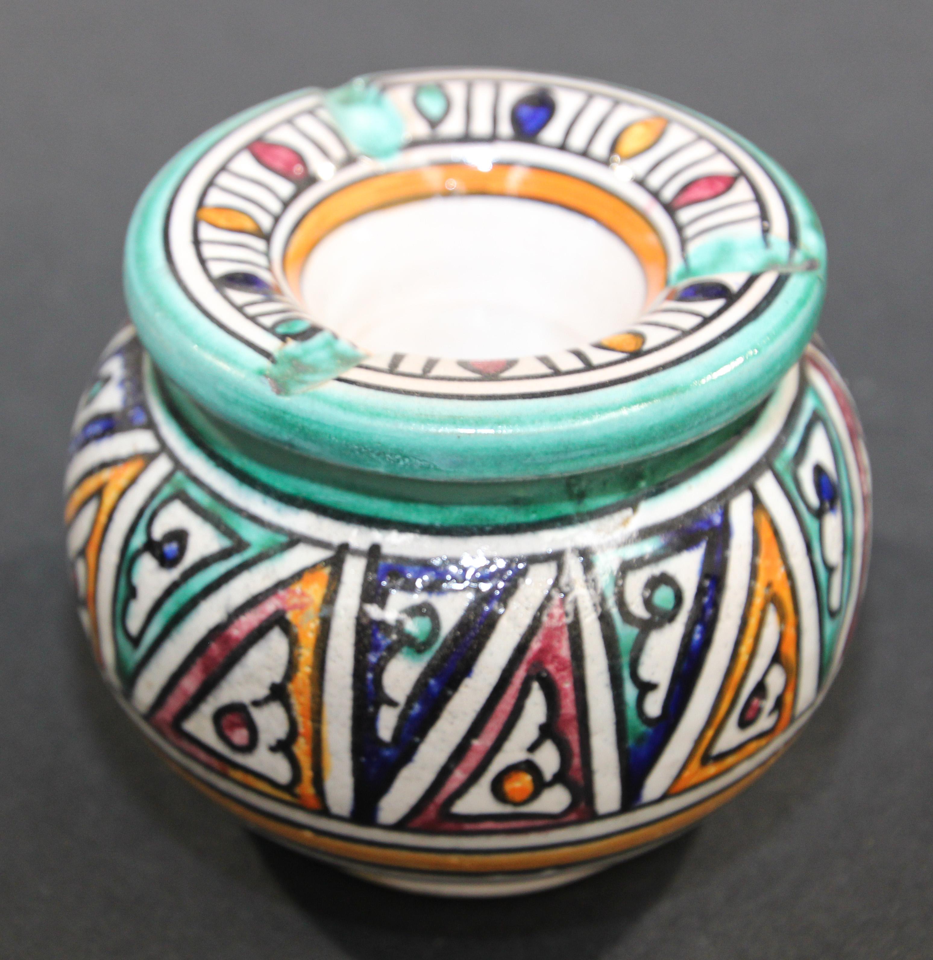 Moroccan covered hand painted ceramic ashtray.
Handcrafted Moroccan ceramic covered ash receiver.
This covered medium size ashtray could be used indoor and outdoor.
If used indoor the cover will keep the smell of ashes in.
Hand painted Moorish