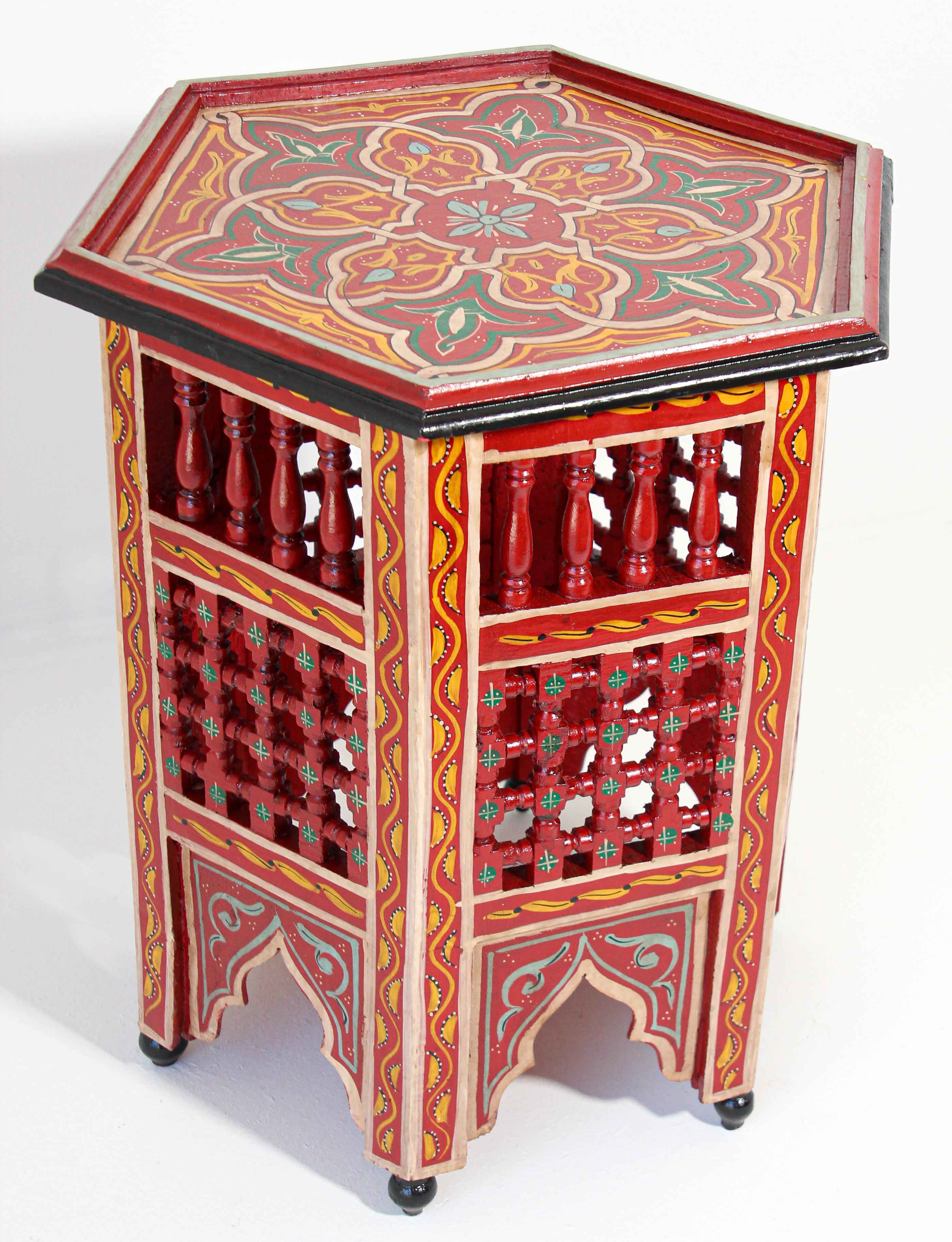 Moroccan red handcrafted and hand painted side table.
Moucharabie fret work octagonal stool with Moorish arches.
Handcrafted in Hispano Moresque style and hand painted on red color background with wine, aqua, green and ochre Moorish floral and