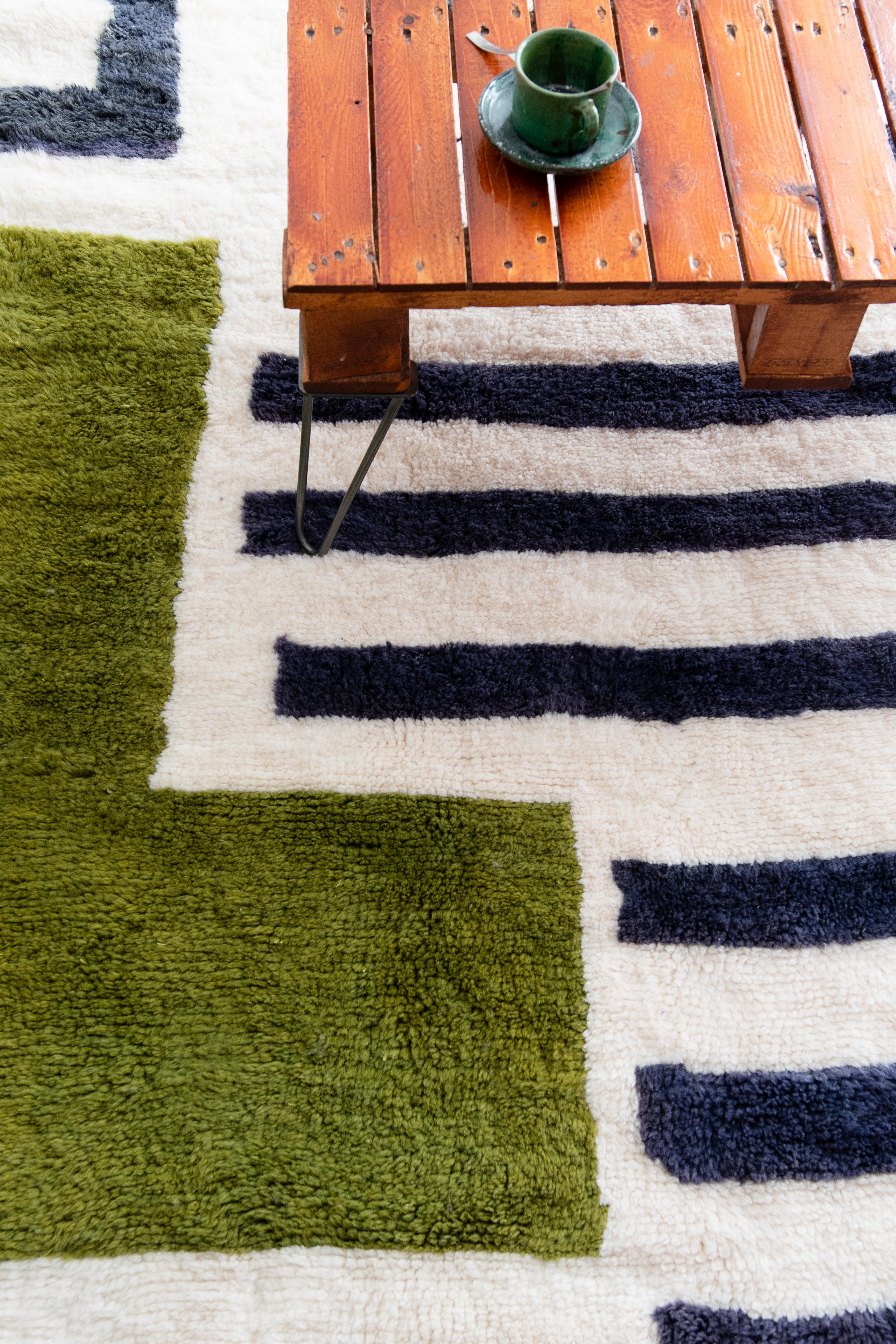 Name of the rug : Shield 
Colors : Green, Blue and White
Material : 100% Natural Wool.
Designer : Garance Tresarrieu
Location : Designed in Paris & Handmade in Morocco 

Designed in Paris by the talented Garance Tresarrieu and handmade using the