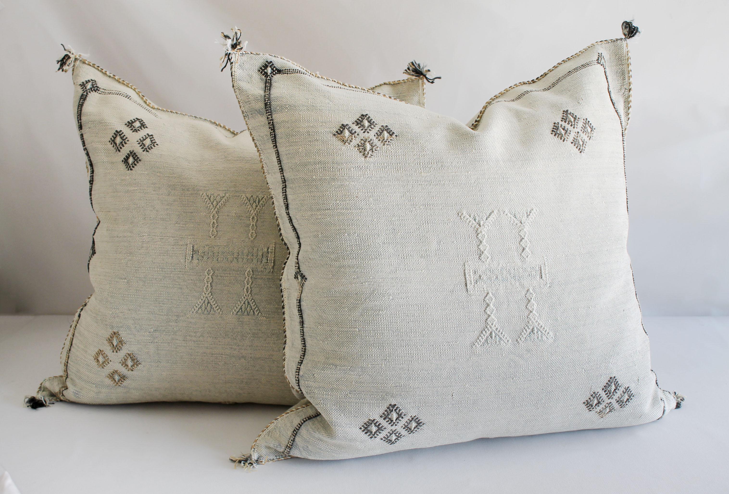 Moroccan handwoven cactus silk pillow.
 As shown with a beautiful light gray tone background, and white, with dark gray and creamy tone accents. Hidden zipper closure, backside is the same plain cactus silk with no embroidery. 
Measures: 22