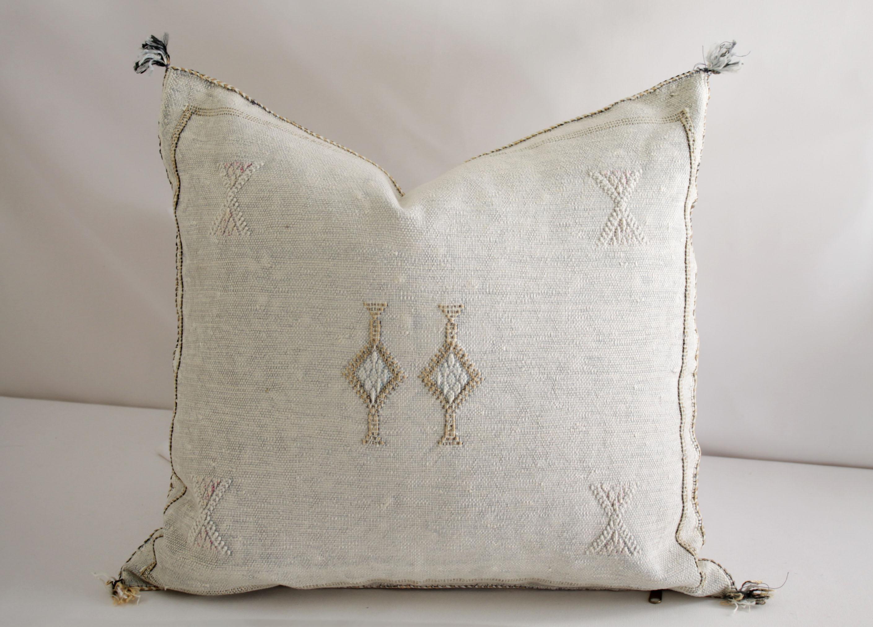Moroccan handwoven cactus silk pillow
As shown with a beautiful light oyster tone background, and white, with light brown accents. Hidden zipper closure, backside is the same plain cactus silk with no embroidery.
Measures: 18? x 18?
Does not