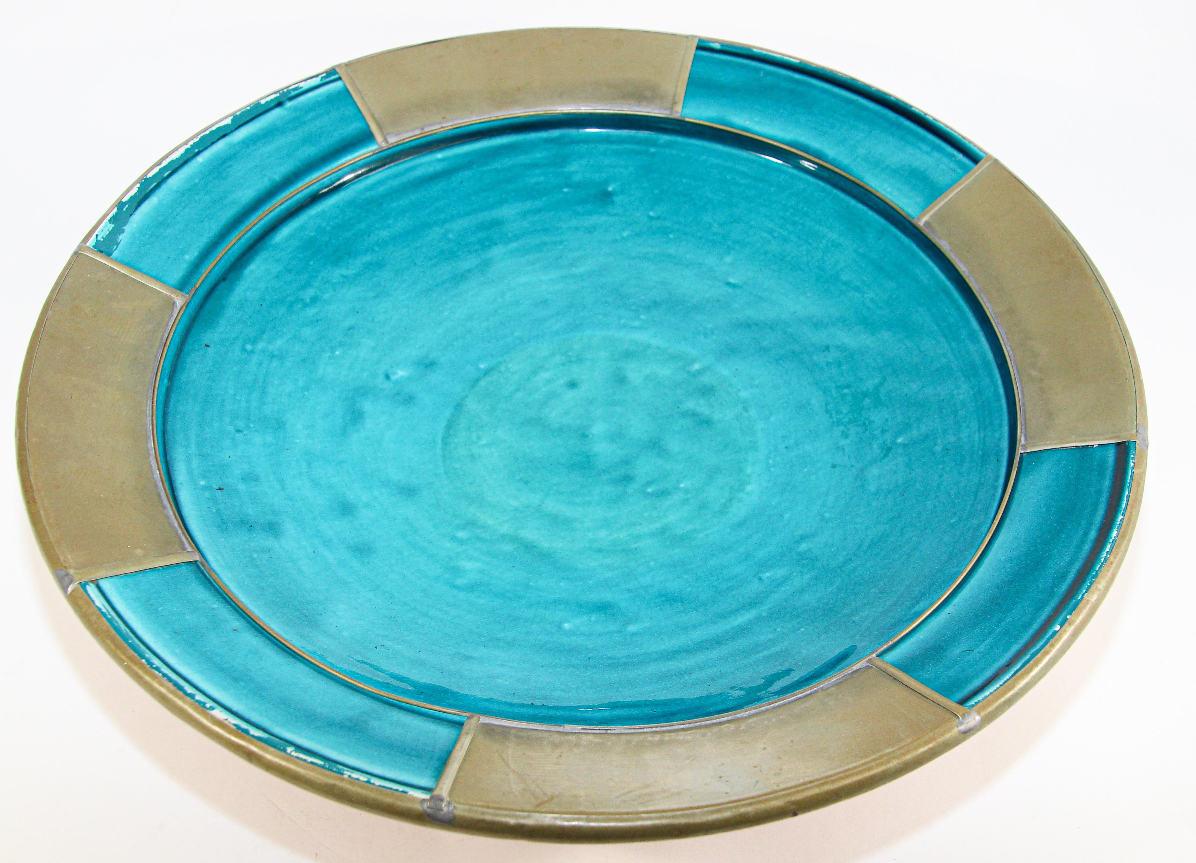 Moroccan handcrafted ceramic turquoise blue bowl decorated with overlaid metal.
Moorish style hand made platter from Safi Morocco.
Could be hanging on the wall or used as a decorative platter.
Size: 15