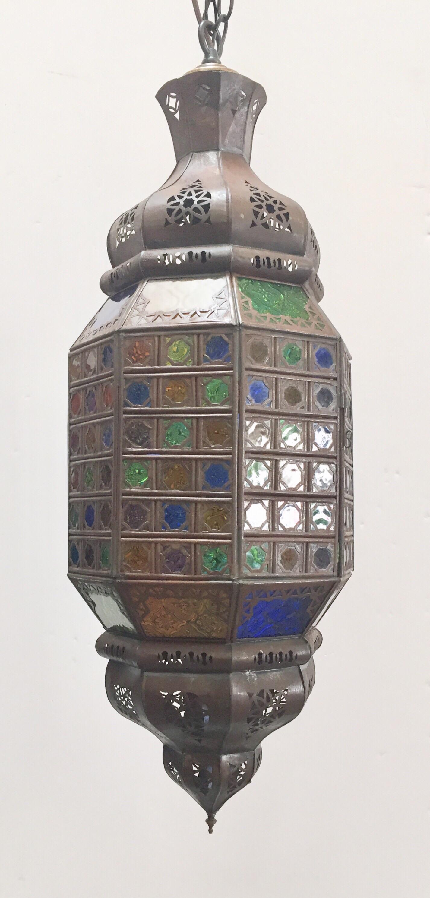 Stylish handcrafted Moroccan pendant with multi-color molded Moorish glass and metal with an antique bronze finish.
Moorish style with dozens of small cut-glass with Moorish openwork filigree metal design in diamond shape.
Rewired for one light