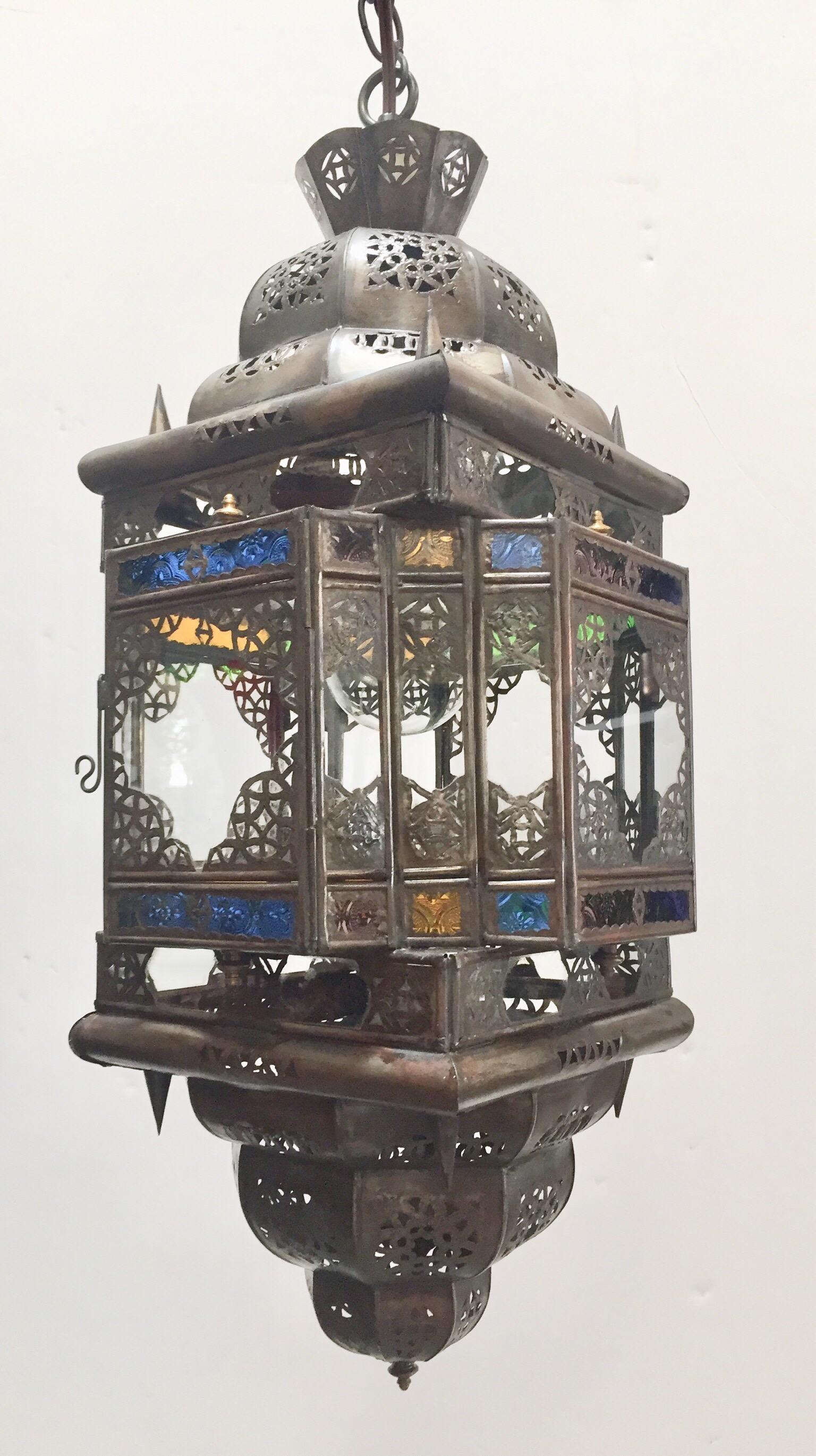 Stylish handcrafted Moroccan pendant with multi-color molded glass and metal with an antique bronze finish.
Moorish style with small cut-glass with open metal filigree work Moorish design in diamond shape.
Vintage Moroccan Hanging Lantern Clear and