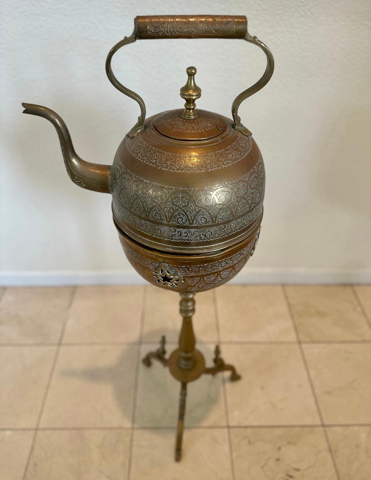 Hand crafted Moroccan antique brass tea kettle pot with warmer on stand., Museum quality, one of a kind antique artistically and delicately handcrafted tea water kettle
The base is made to hold the kettle hot by putting coal in it
Total Weight is
