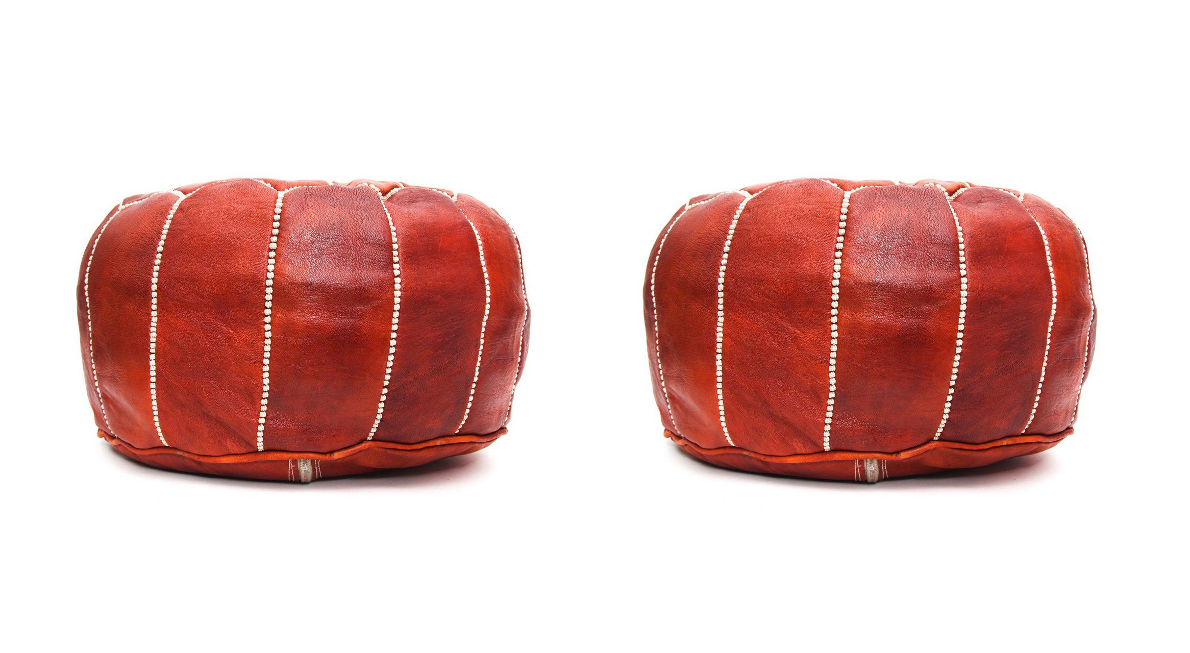 This eye-catching handstitched genuine dark leather pair of Moroccan Poufs will lend an air of regal majesty to your den or living room. Handcrafted in leather by master artisans and boasting a resplendent arabesque pattern, this pair of poufs is