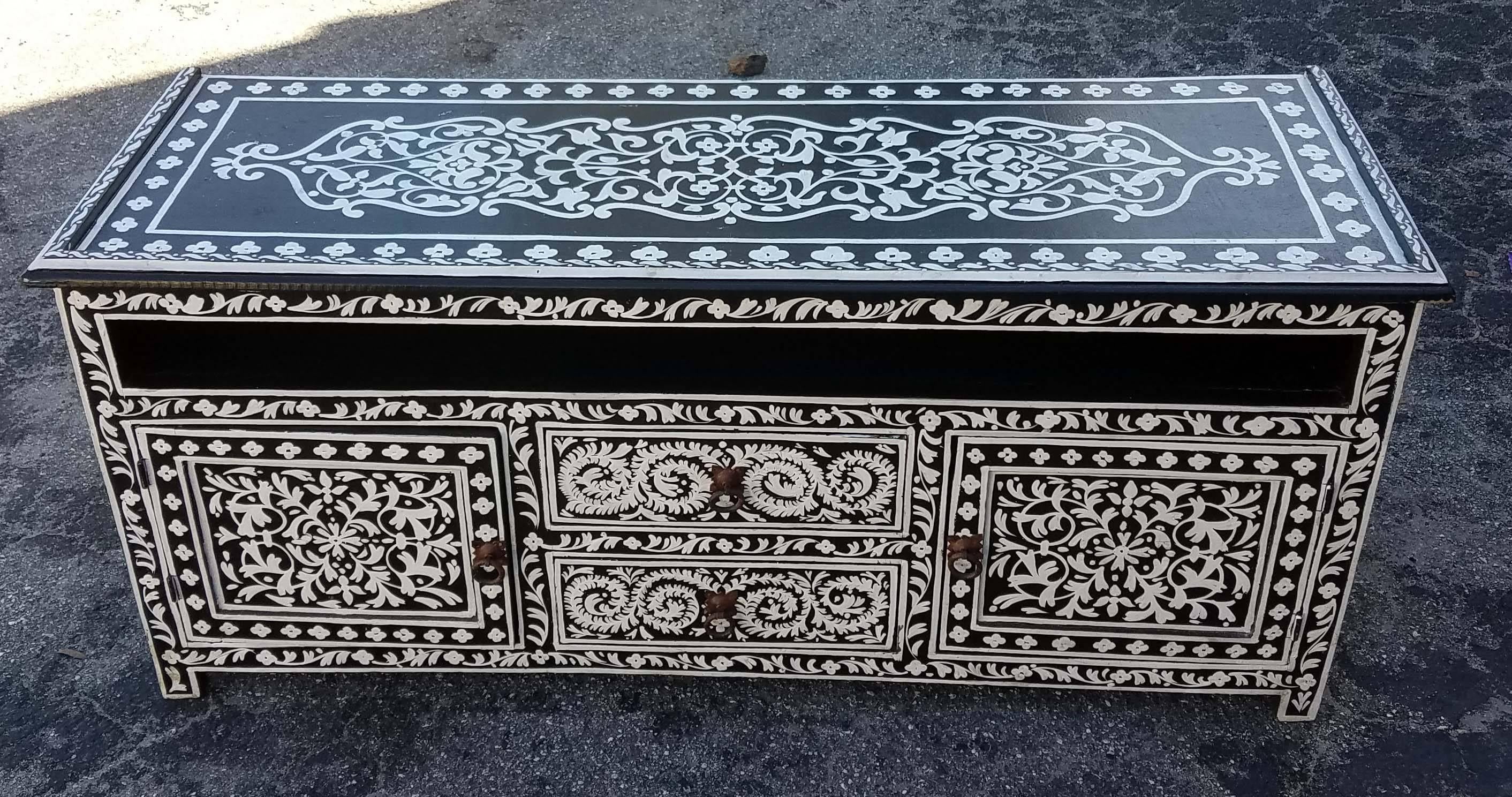 Beautifully hand-painted Moroccan wooden media stand. With its detailed handcraftsmanship along the sides and the top, this cabinet will sure be a excellent add-on to your décor. It measures approximately 48