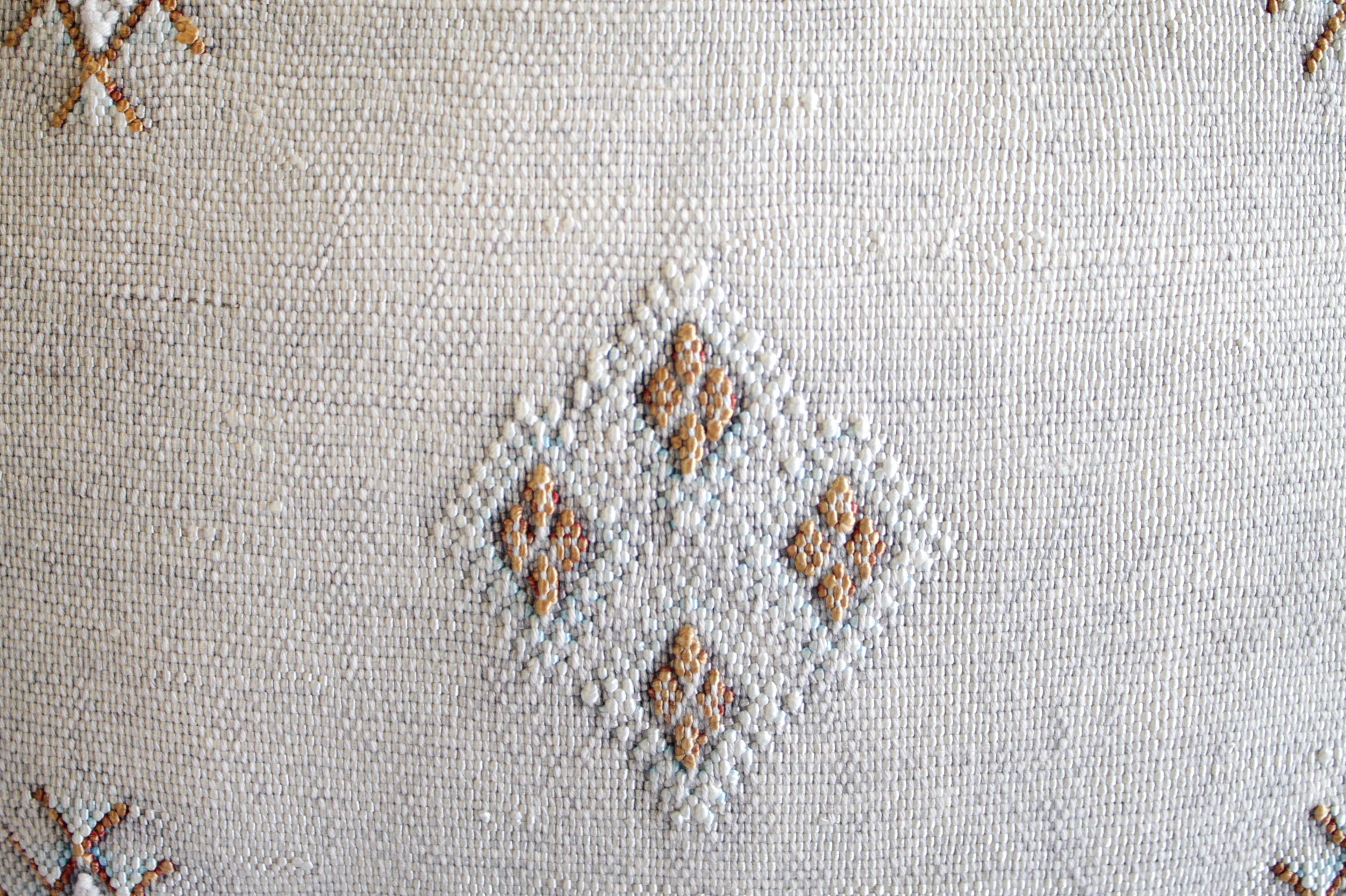 Moroccan handwoven cactus silk pillow as shown with a beautiful light gray tone background, and white, with golden brown accents, backside is the same plain cactus silk with no embroidery. 
Limited quantities available as these are 1 of a kind.