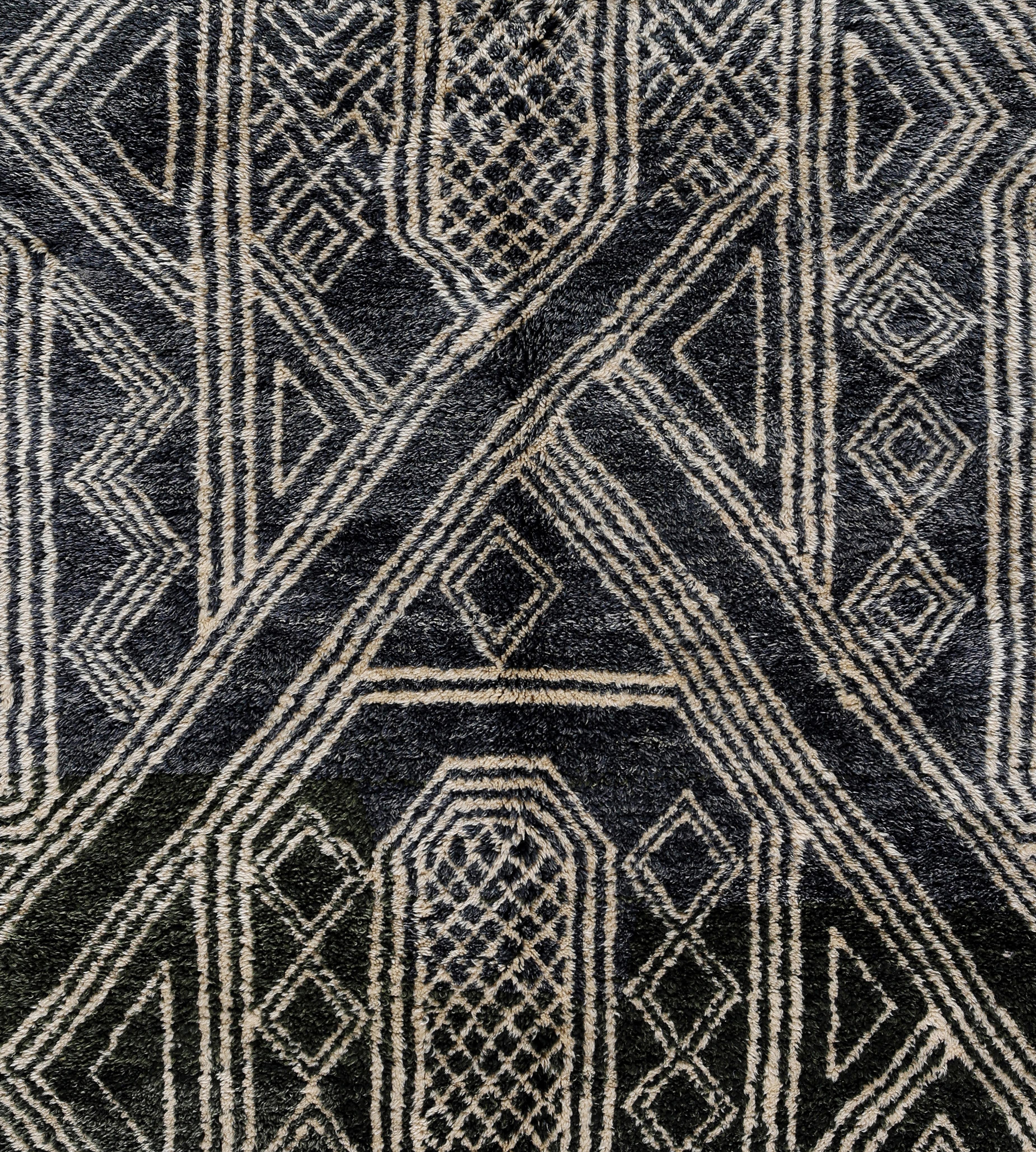 This one-of-a-kind Moroccan wool rug is handwoven by Berber artisans using traditional flatweave techniques and features a bold tribal geometric composition in rich indigo blue and ivory tones. The repeating diamond and linear lattice patterns