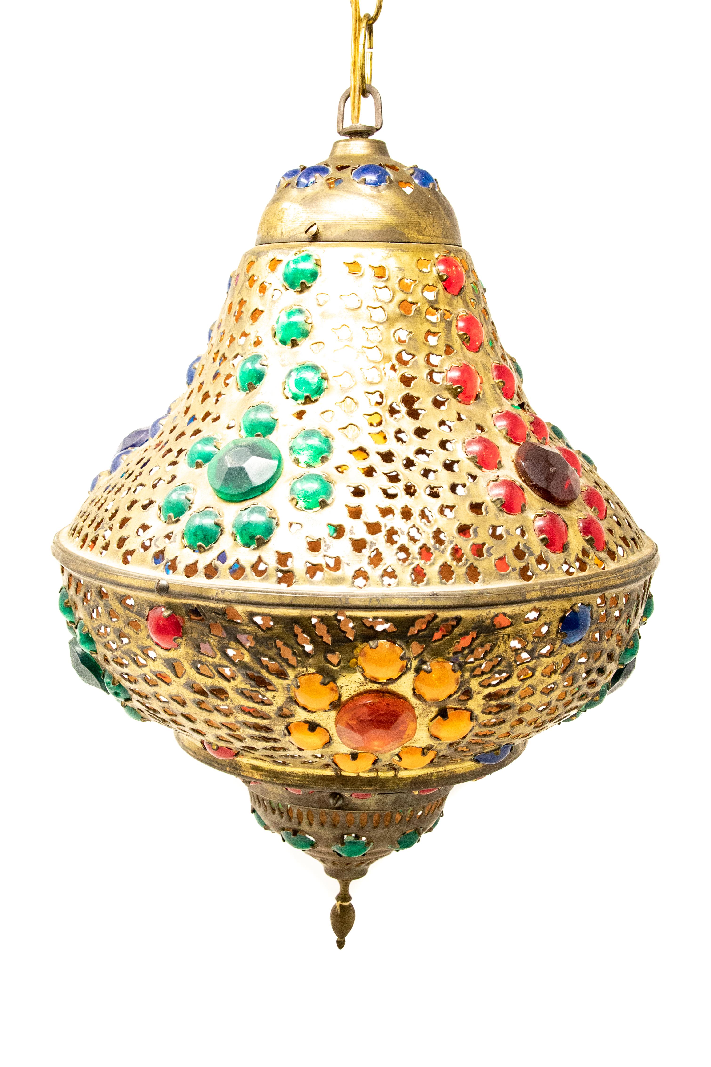 Offering this stunning Moroccan hanging lamp. Made of solid brass with jewel toned faceted cut stones. It is wired and does work.