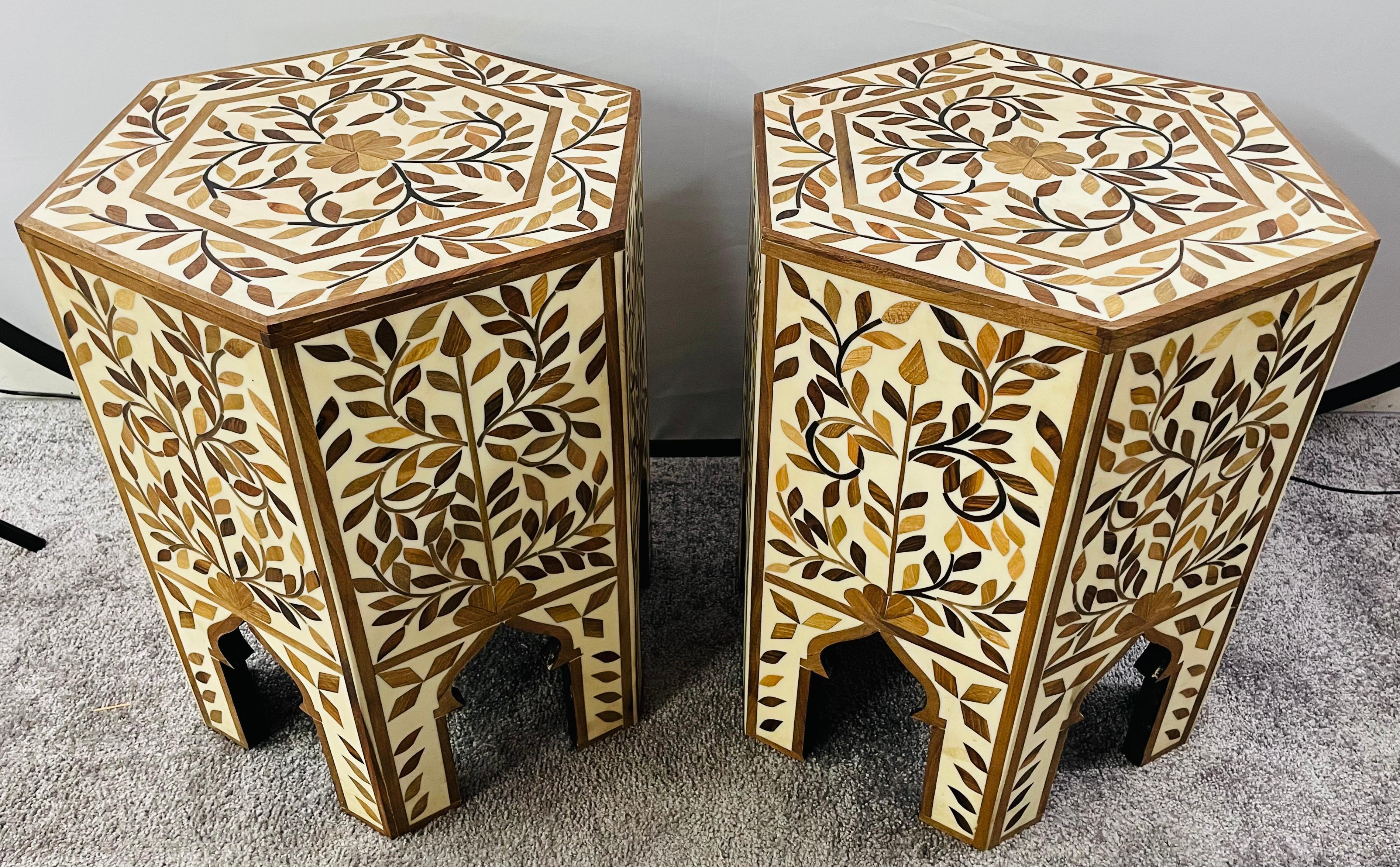 An exquisite pair of Moroccan side or end table featuring an hexagonal shape. The handmade tables are finely decorated in leaves Pattern and beautiful arches, a staple of the moorish timeless architecture and design. Hand made of resin in an off