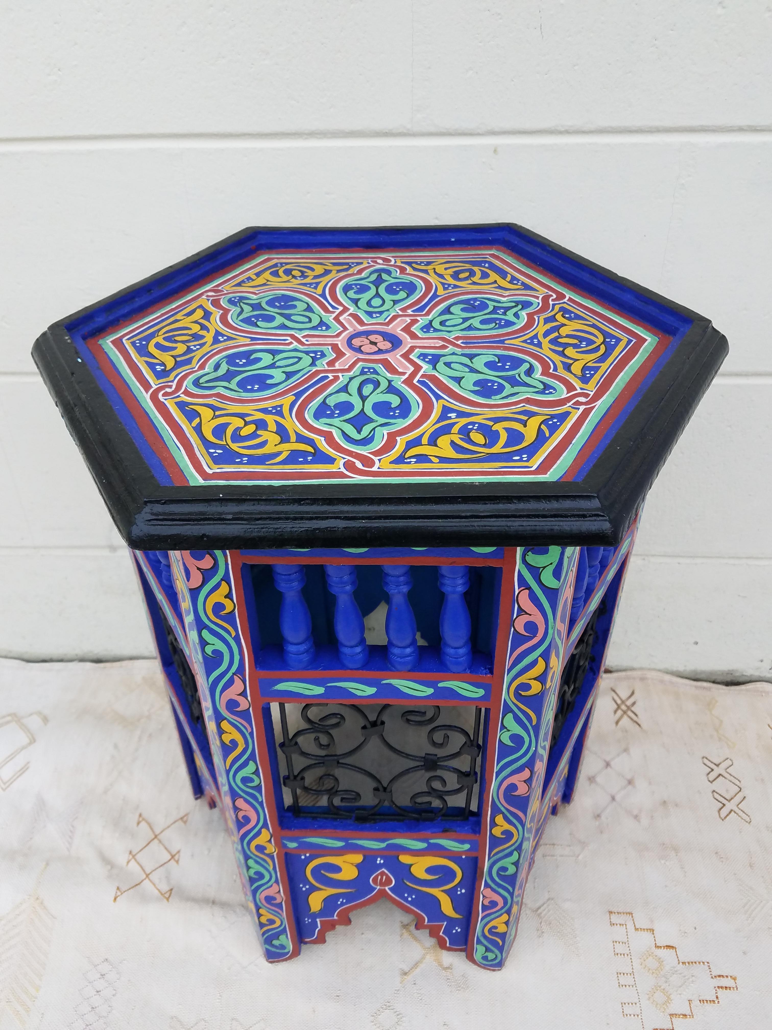 This is a 100% hand painted and hand carved Moroccan hexagonal shape side table or end table. Great handcraftsmanship throughout, featuring the famous Moroccan metal scroll work. Beautiful add-on to your home or office decor. This table measures