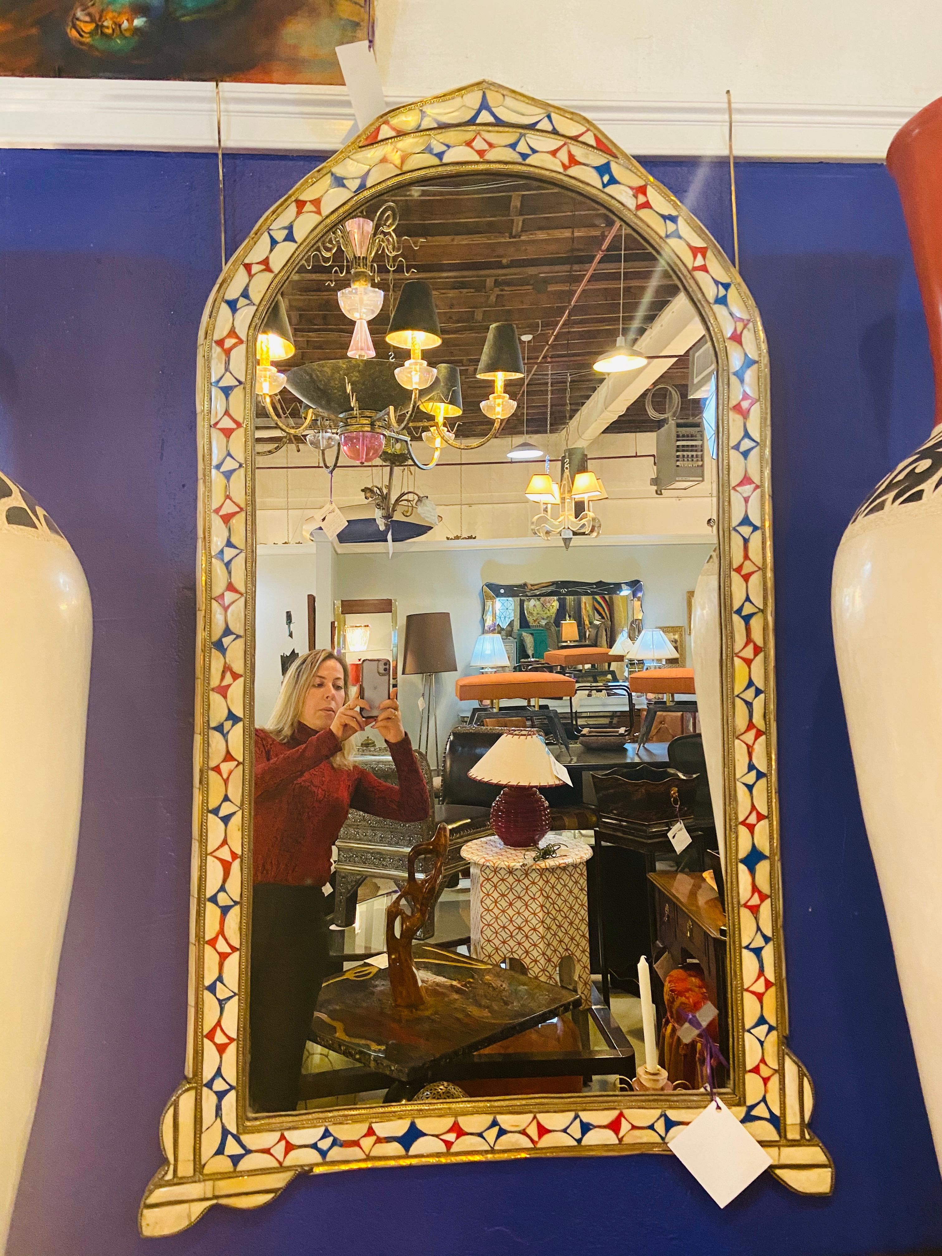 Moroccan Hollywood Regency Style Bone over Brass Inlay Floor or Wall Mirror in White , Red and Blue. 
A gorgeous 1980s Hollywood Regency style decorators delight floor and wall mirror, featuring natural Camel bone in red, blue and white color. The