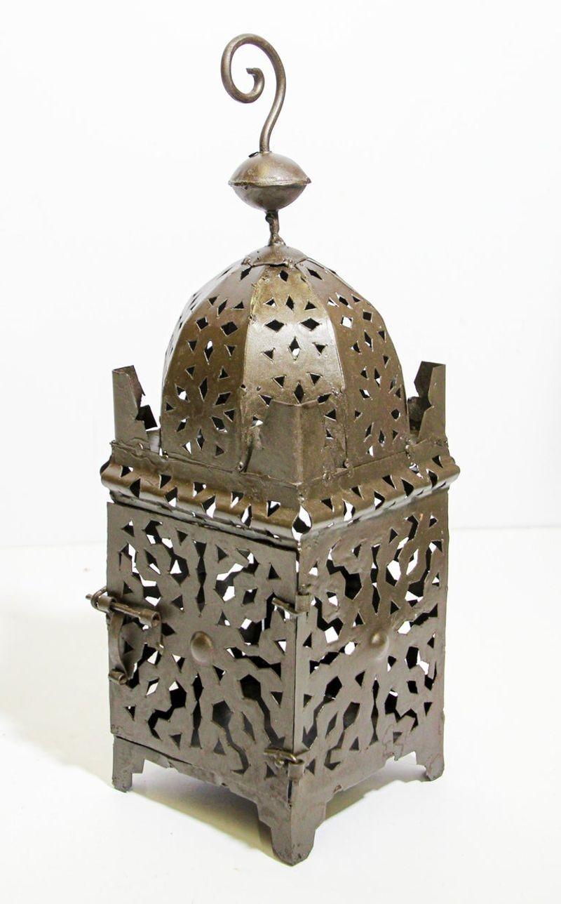 Moroccan Moorish metal candle lantern.
Hurricane candle lamp handcrafted in Morocco by artisans, metal hand-cut openwork and hammered with Moorish design, open in front for use with pillar candles.
The candle lanterns are great to use indoor or
