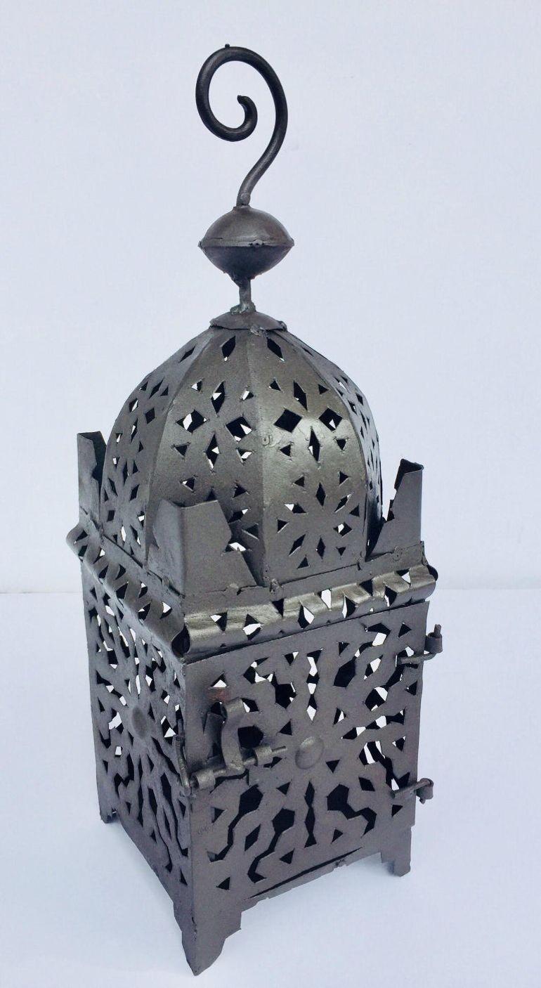 Moroccan Moorish metal candle lantern. Hurricane candle lamp handcrafted in Morocco by artisans, metal hand-cut openwork and hammered with Moorish design, open in front for use with pillar candles.
The candle lanterns are great to use indoor.
Size