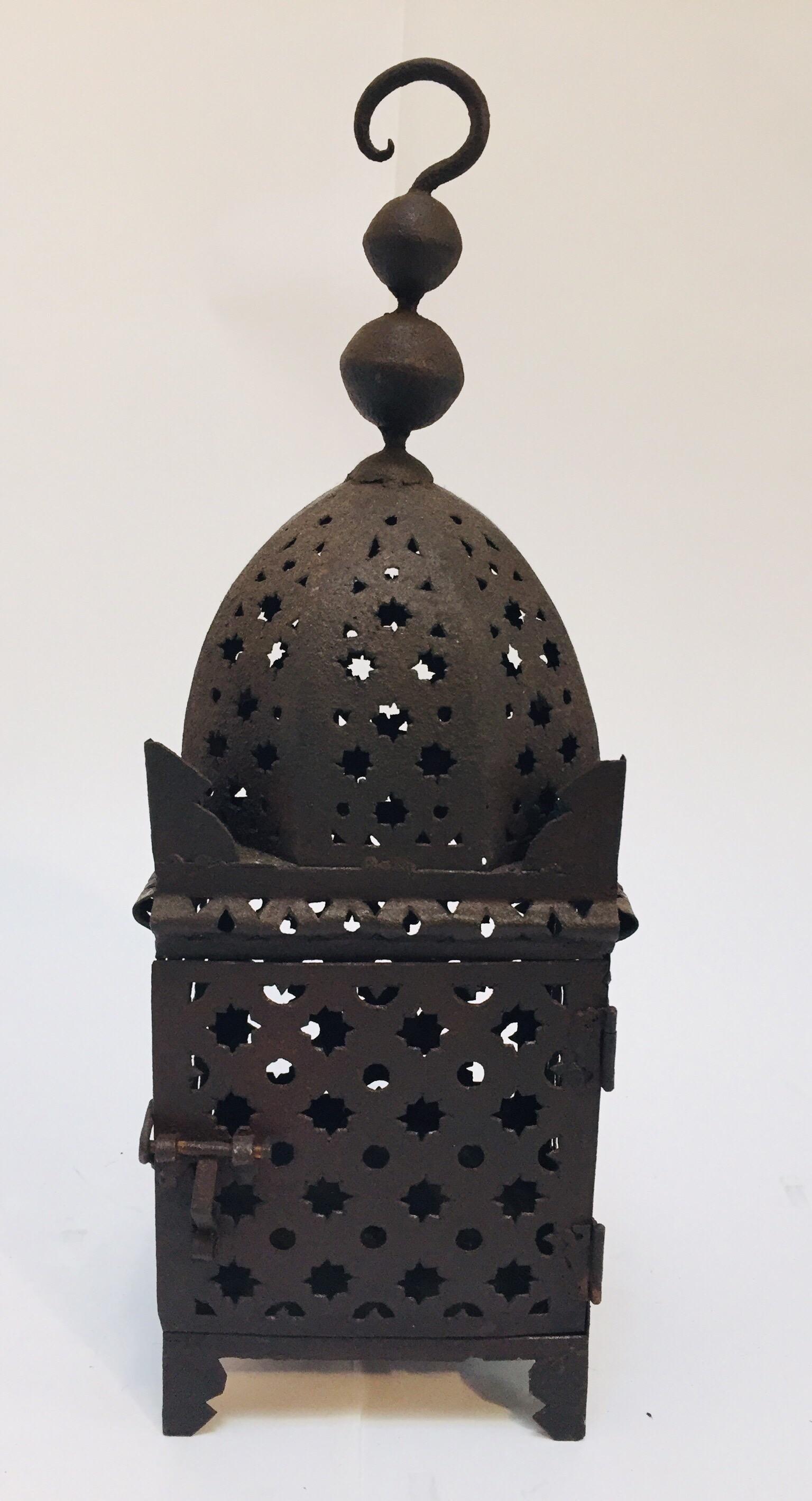 Moroccan Moorish metal candle lantern. Hurricane candle lamp handcrafted in Morocco by artisans, metal openwork and hammered with Moorish design, opens in front for use with pillar candles. The candle lanterns are great to use indoor or