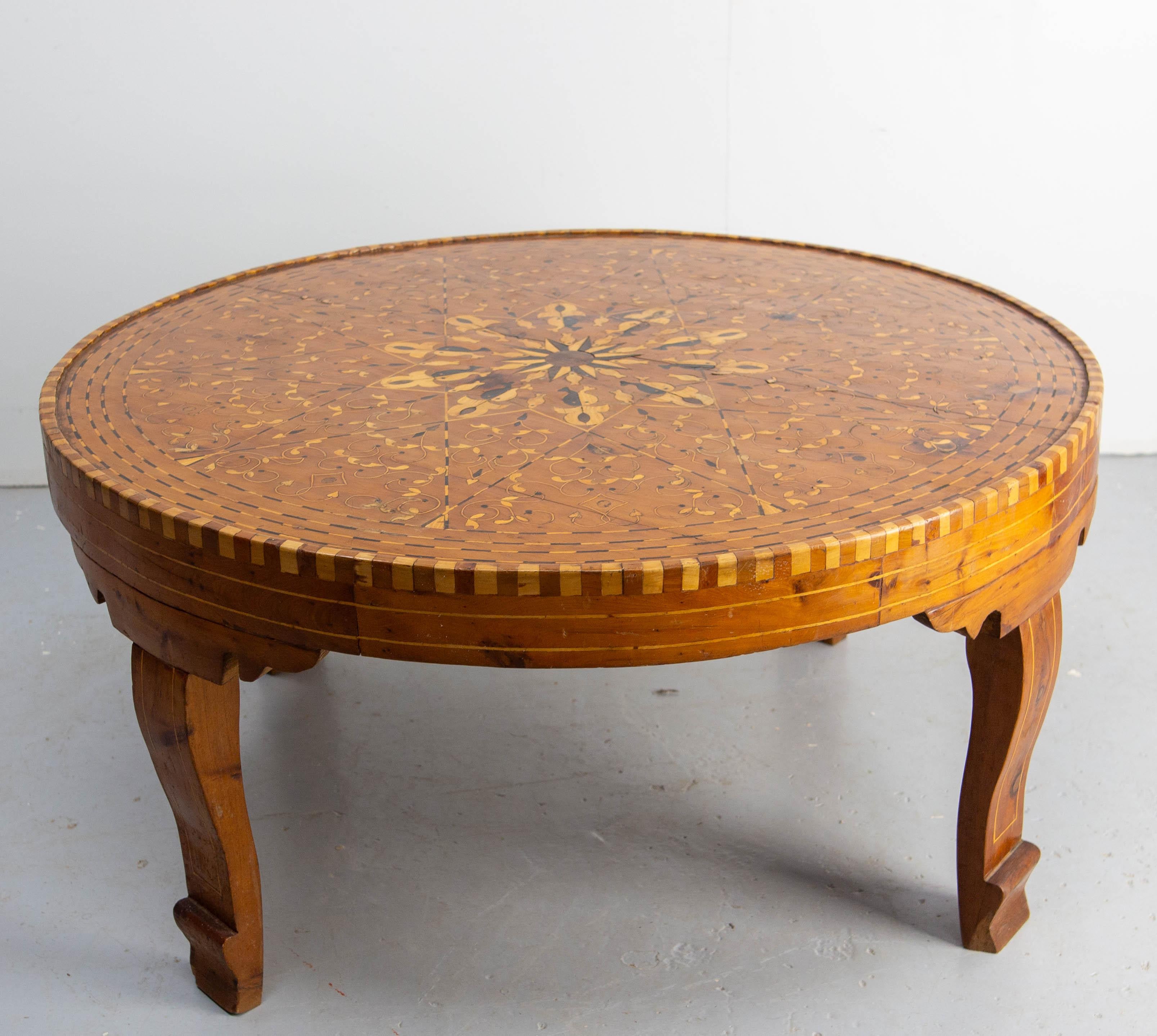Moroccan central table inlaid with different woods espacially Atlas cedar 19th century.
A crack between the differents peaces of wood crack runs across the top table.
This is  not structural and testifies of the old age of this item (please see two