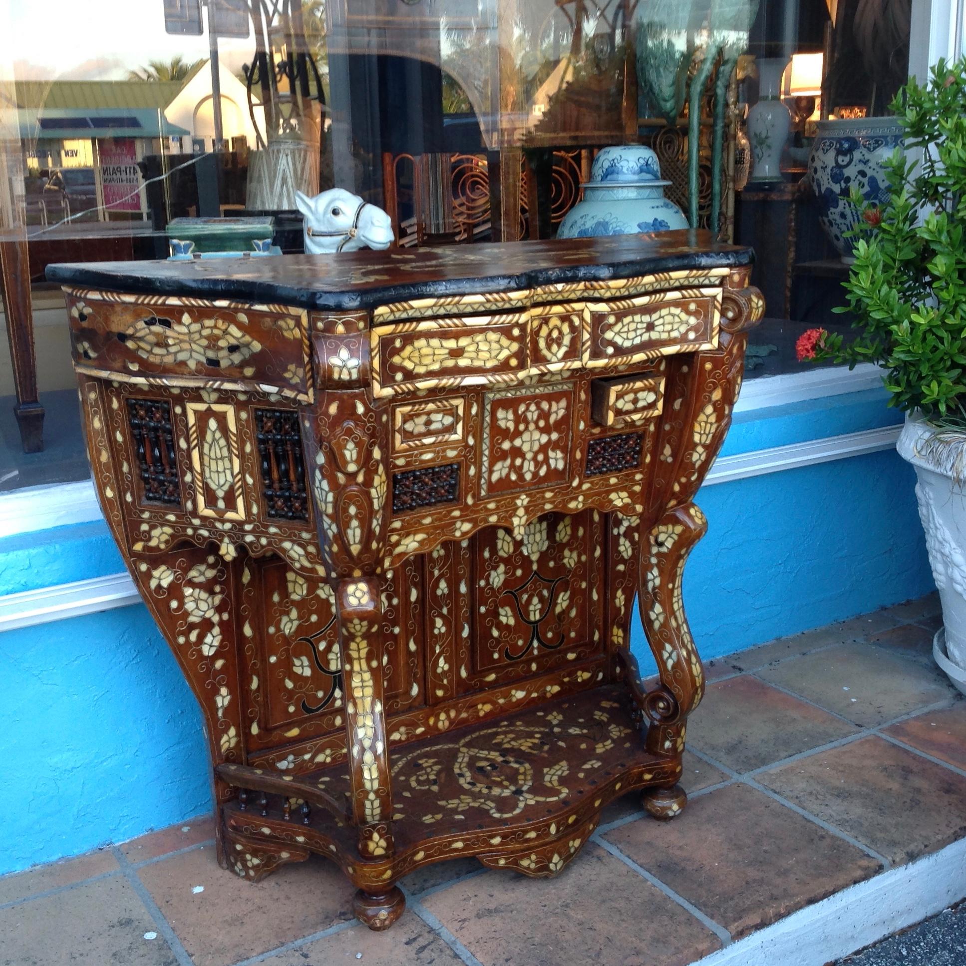 Dramatic style and flair to this ornately inlaid and unusual console fitted with 
a large top drawer and 2 smaller drawers.
The open carving is ornate.