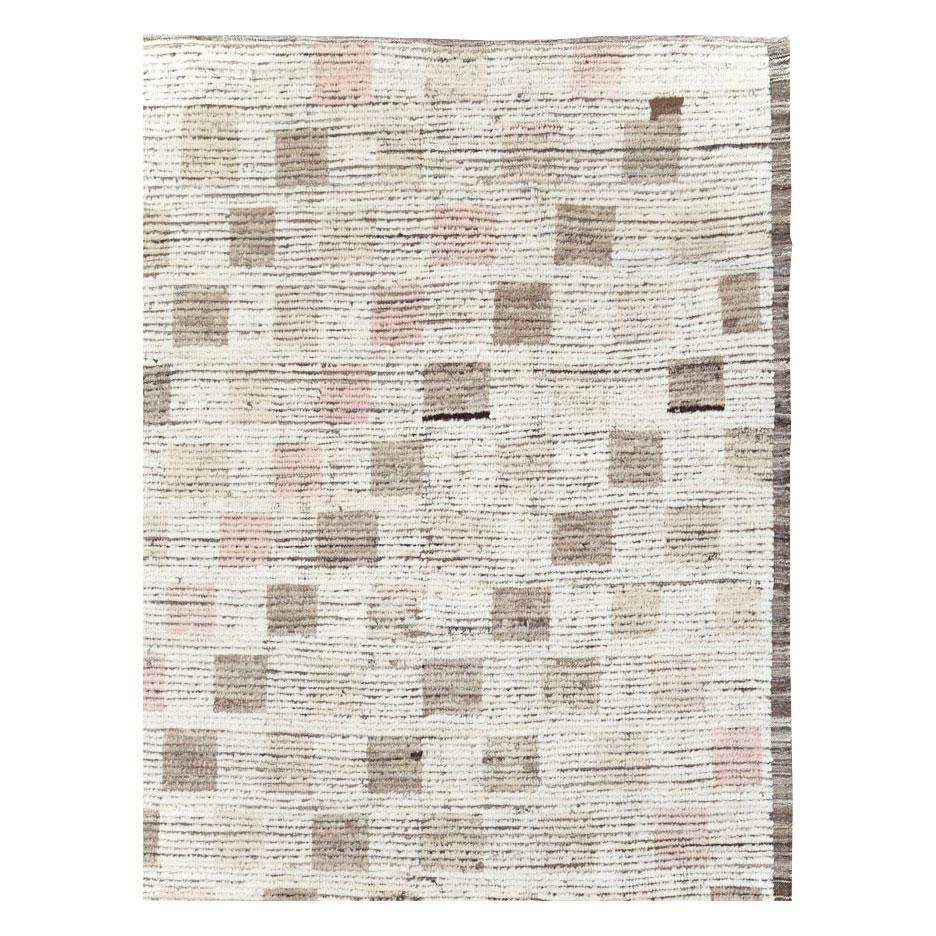 A contemporary Turkish room size carpet in shades of cream, brown, and pastel pink, handmade during the 21st century inspired by Moroccan carpets from the mid-20th century period.

Measures: 9' 4
