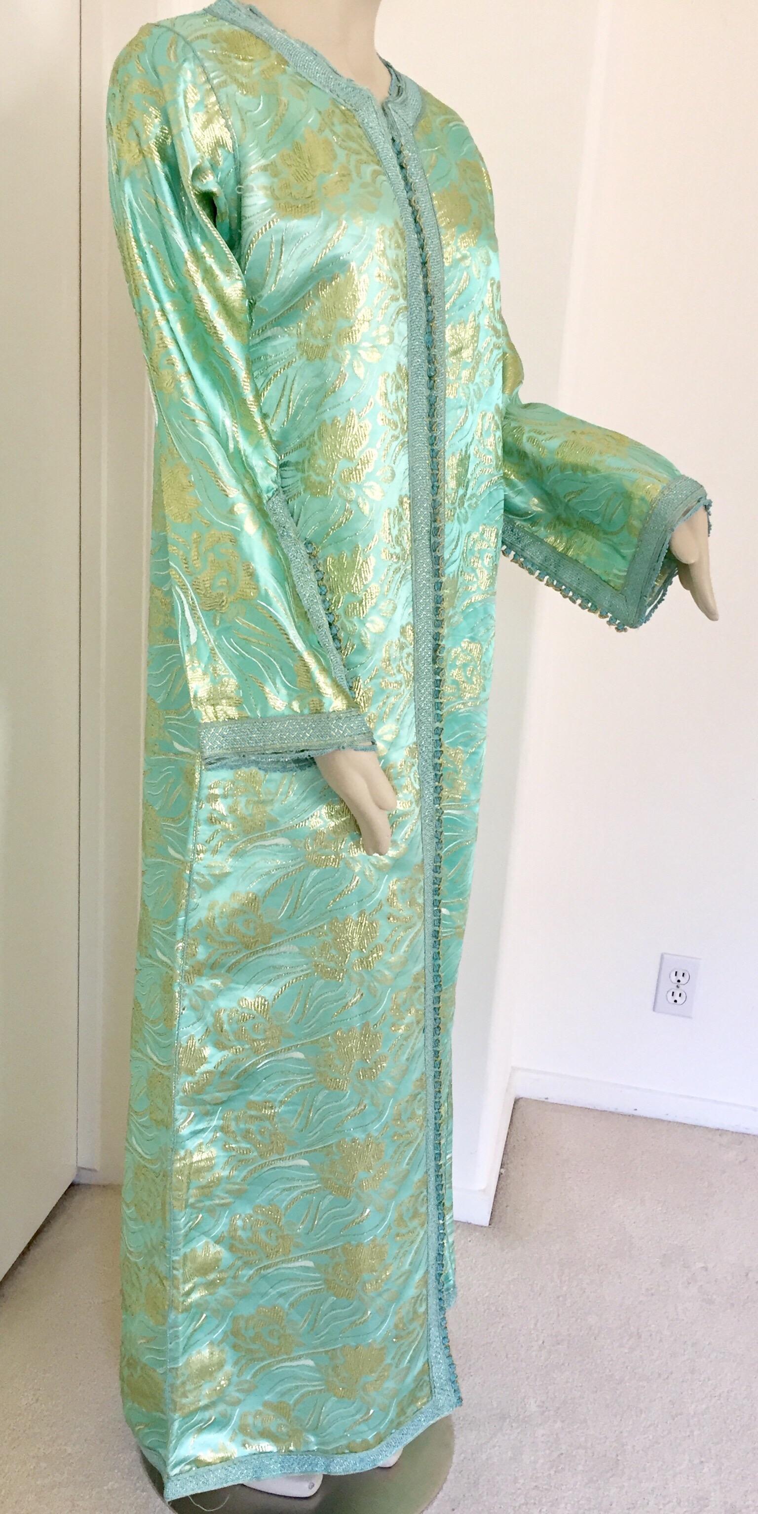 Elegant Moroccan caftan in turquoise and gold floral lame metallic and embroidered trim,
circa 1970s.
This long maxi dress kaftan is embroidered and embellished entirely by hand. 
It’s crafted in Morocco and tailored for a relaxed fit.
One of a kind
