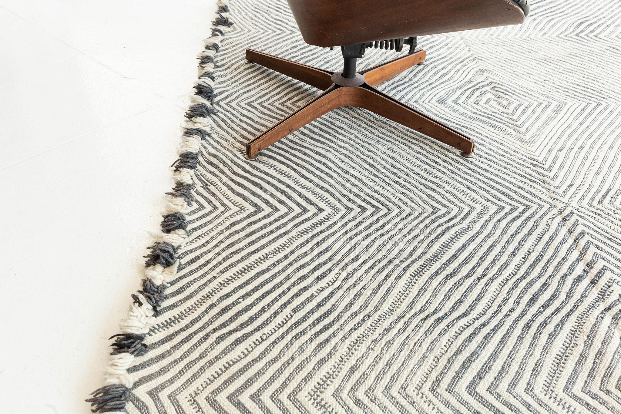 Featuring a glorious illusion effect, this Moroccan Kilim rug adds texture and subtle graphic appeal forming a warm, relaxed space. The abrashed field is covered in an all-over diamond effect reminiscent of a kaleidoscope across the tantalizing and