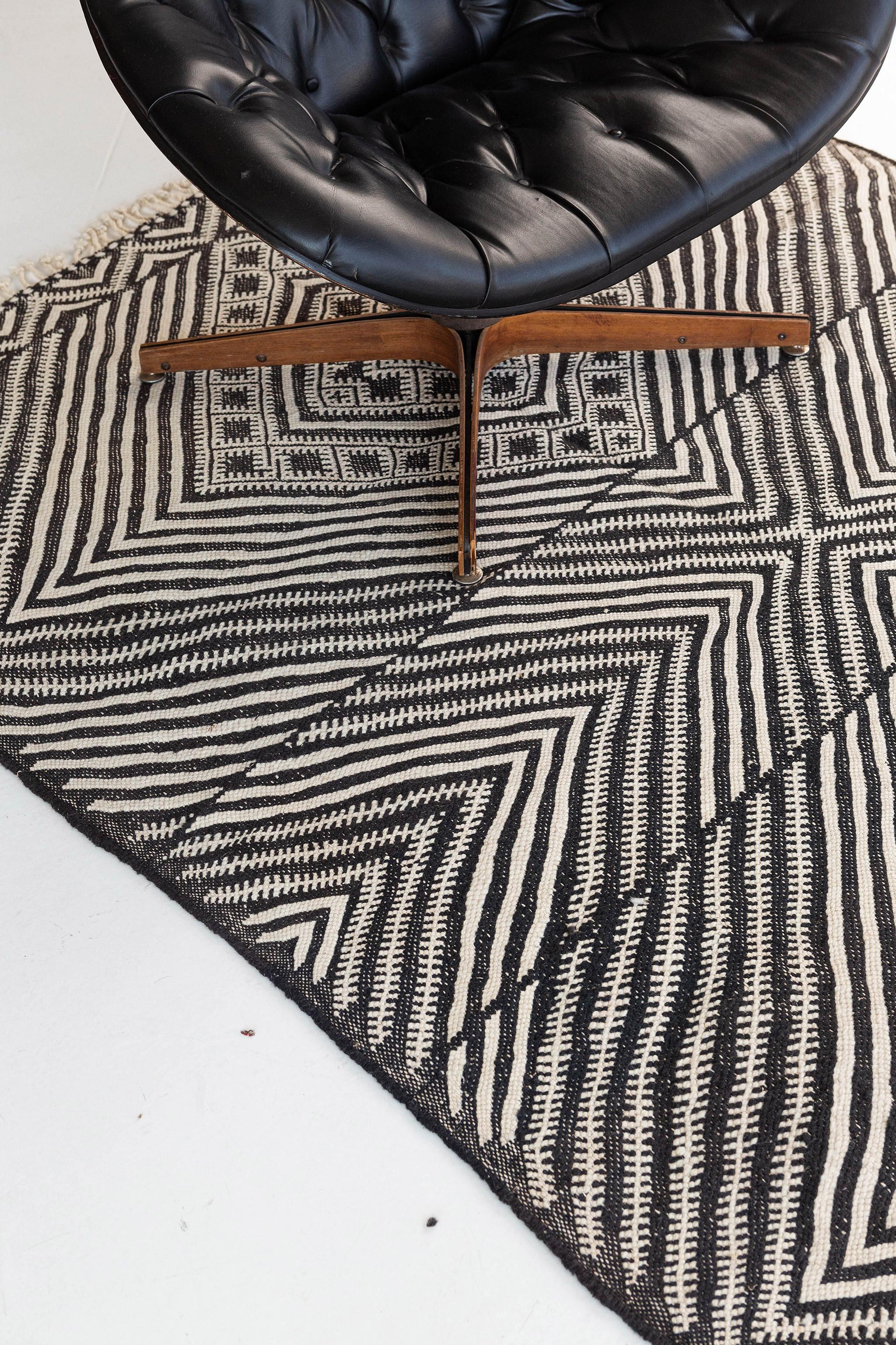 Featuring a stunning effect creating a lozenge scheme, this Moroccan Kilim rug adds texture and subtle graphic appeal forming a warm, relaxed space. The abrashed field is covered in an all-over diamond effect partridge eyes across the tantalizing