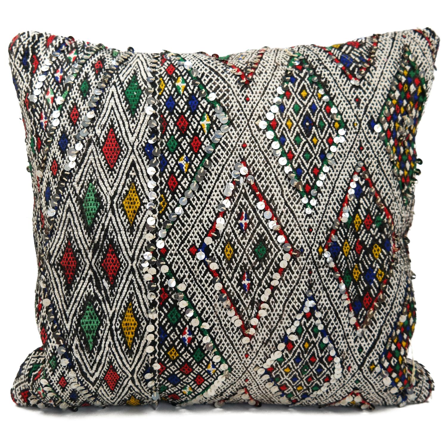 A stunning Bohemian Moroccan Kilim cushion custom made in Morocco. Cut from a circa 40 years old hand loomed Kilim rug, from the Middle Atlas mountains. We have searched and selected the rug ourselves. The pillow has beautiful colors like red,