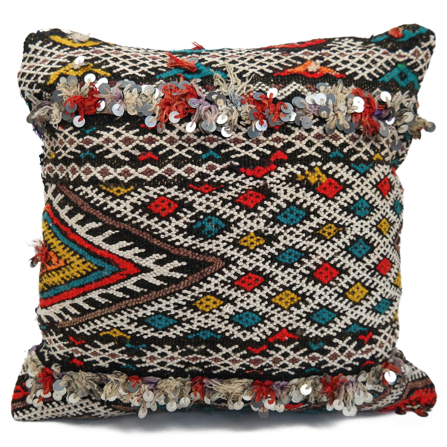 A stunning Bohemian Moroccan Kilim cushion custom made in Morocco. Cut from a circa 40 years old hand loomed Kilim rug, from the Middle Atlas mountains. We have searched and selected the rug ourselves. The pillow has beautiful colors like red,