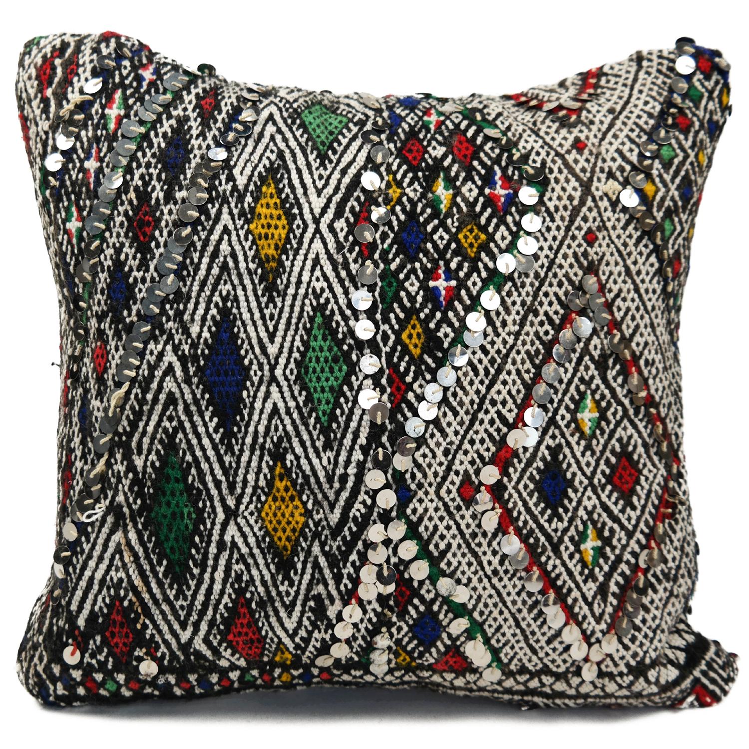 A stunning Bohemian Moroccan Kilim cushion custom made in Morocco. Cut from a circa 40 years old hand loomed Kilim rug, from the Middle Atlas mountains. We have searched and selected the rug ourselves. The pillow has beautiful colors like red,