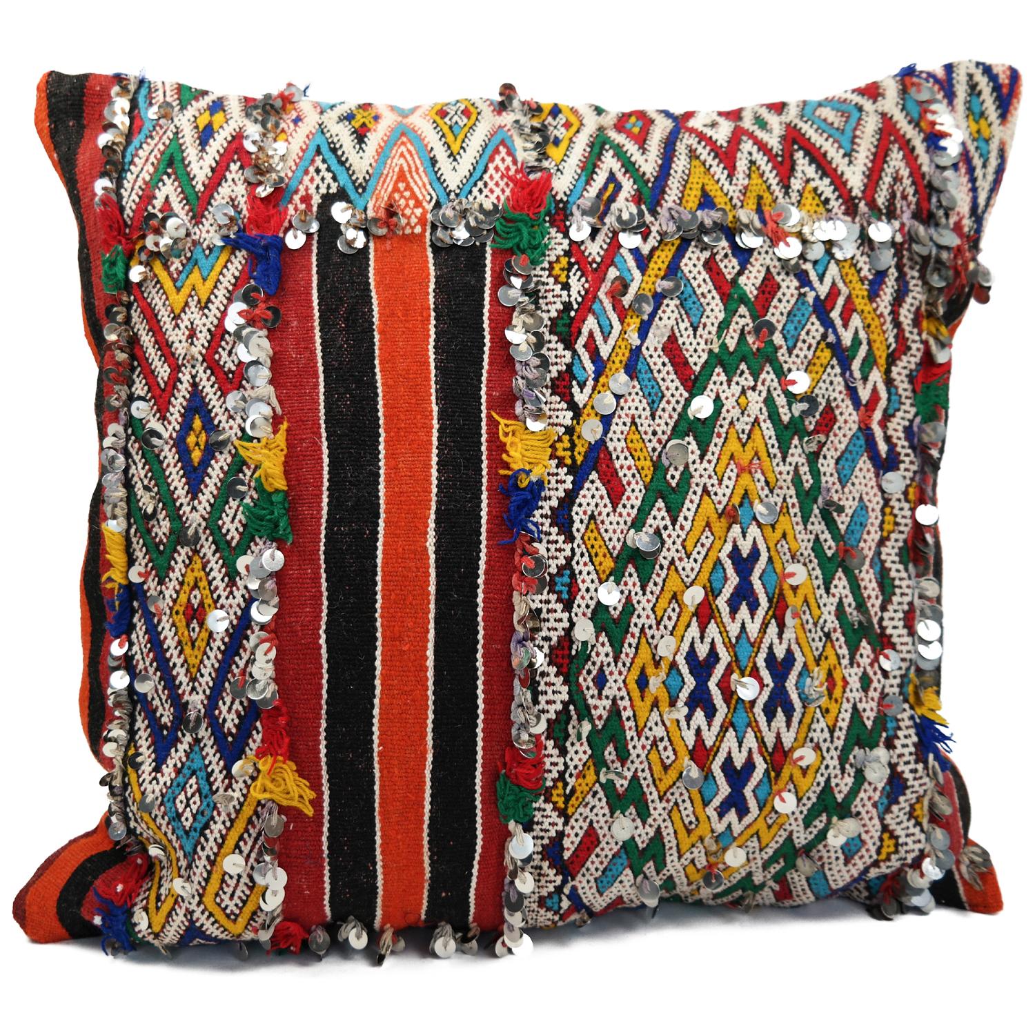 A stunning Bohemian Moroccan Kilim cushion custom made in Morocco. Cut from a circa 40 years old hand loomed Kilim rug, from the Middle Atlas mountains. We have searched and selected the rug ourselves. The pillow has beautiful colors like red,