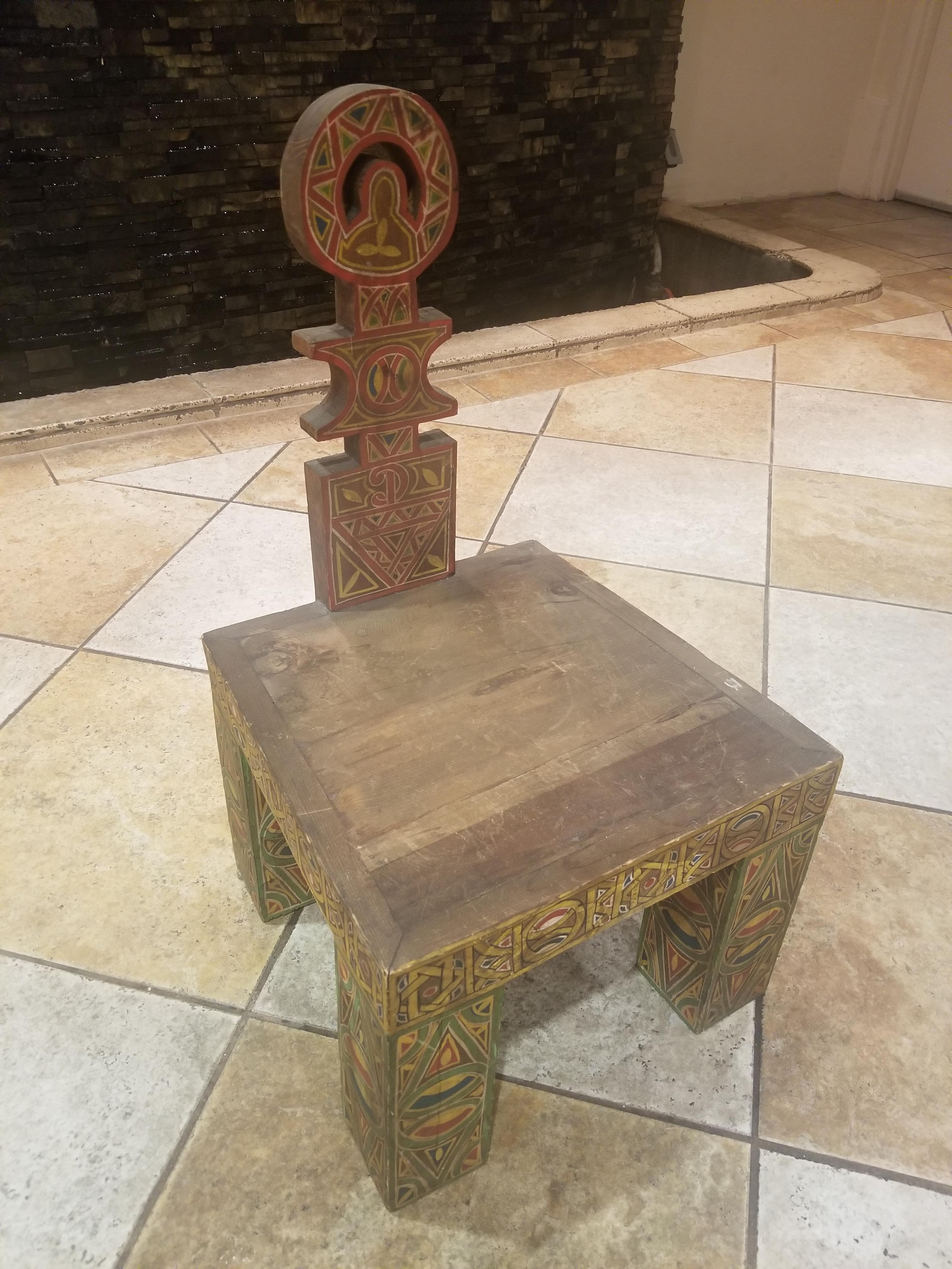 Moroccan wooden chair. Meticulous hand carving and hand painting throughout. Fine cedar wood. This is one of the funkiest chairs we've ever had in our showroom. Amazing work and handcraftsmanship makes this amazing piece a one of a kind. Seating is